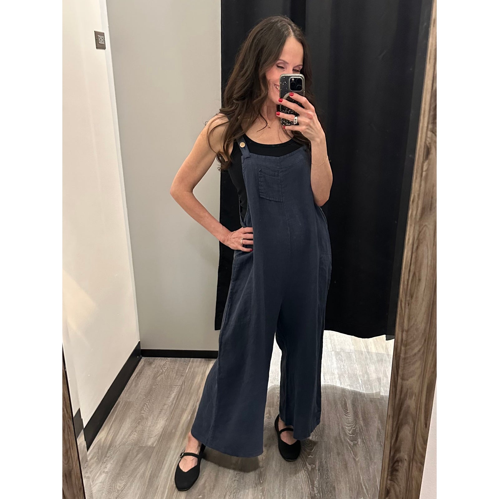 Model wearing Sorella Linen Jumpsuit with Pockets in navy, oversized fit, front pocket, shoulder straps; 100% linen.