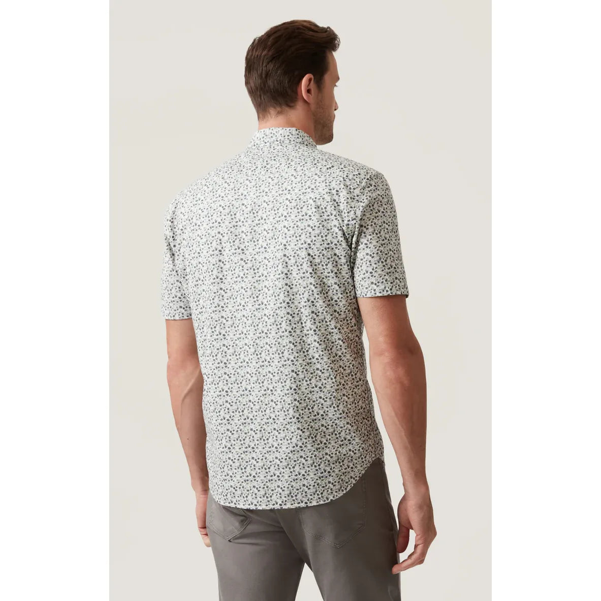 Back view of a man wearing the 34 Heritage Grove Short Sleeve Shirt with a white floral print.