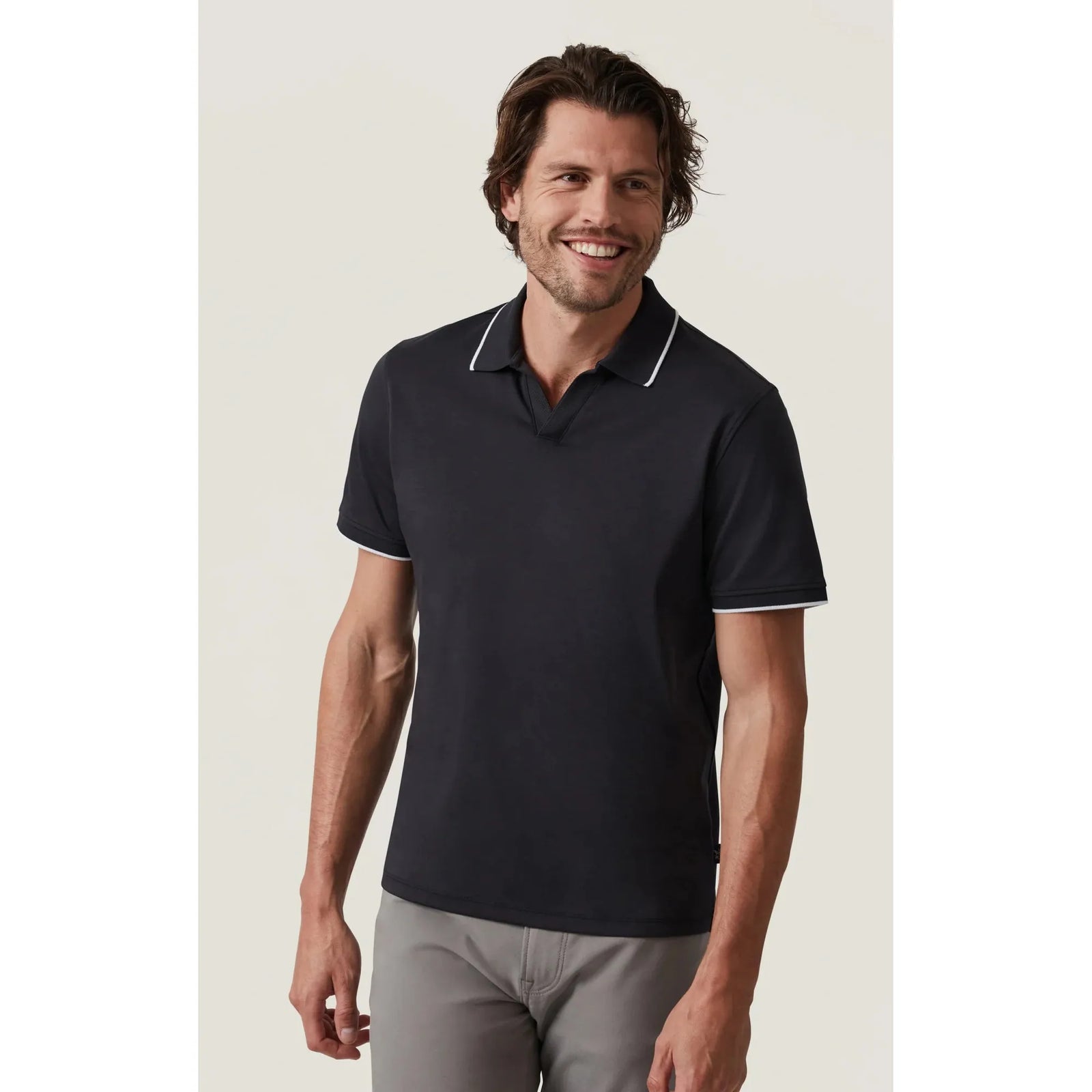 Stylish man models the 34 Heritage Riviera Polo, featuring white lining for a polished look perfect for any occasion.