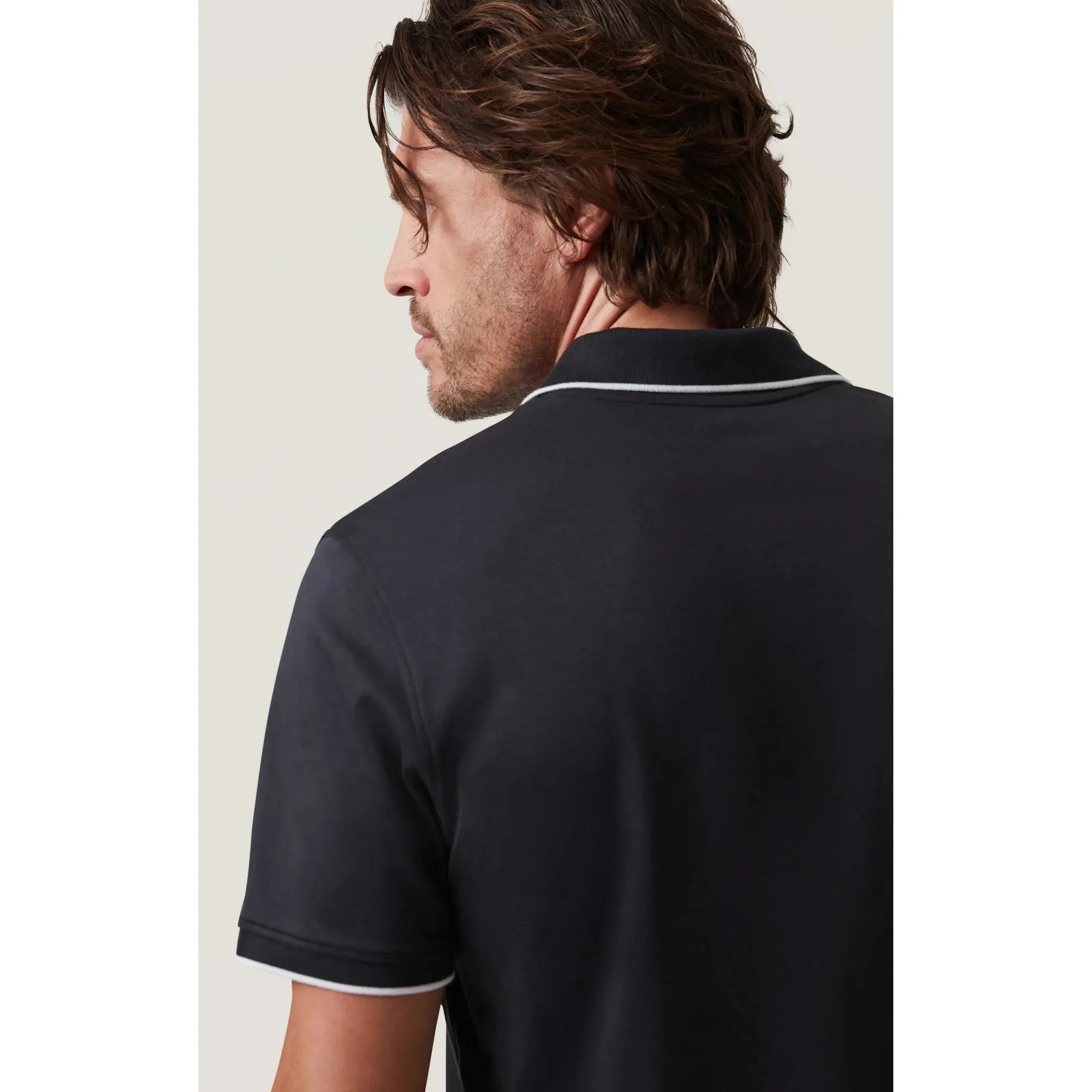Stylish 34 Heritage Riviera Polo in black, featuring elegant white lining on sleeves and neck for a modern look.
