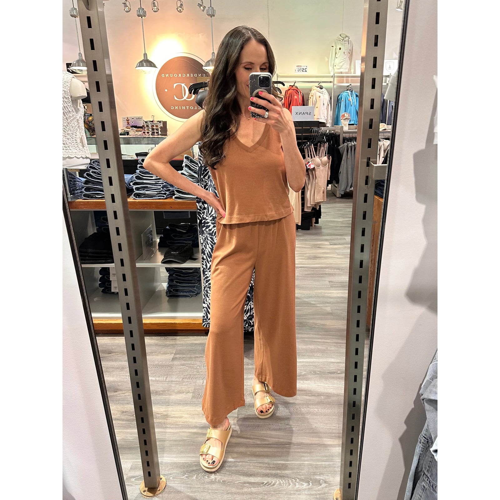 Model wearing camel Z Supply Scout Jersey Flare Pant with matching tank, high-rise wide-leg in a boutique.