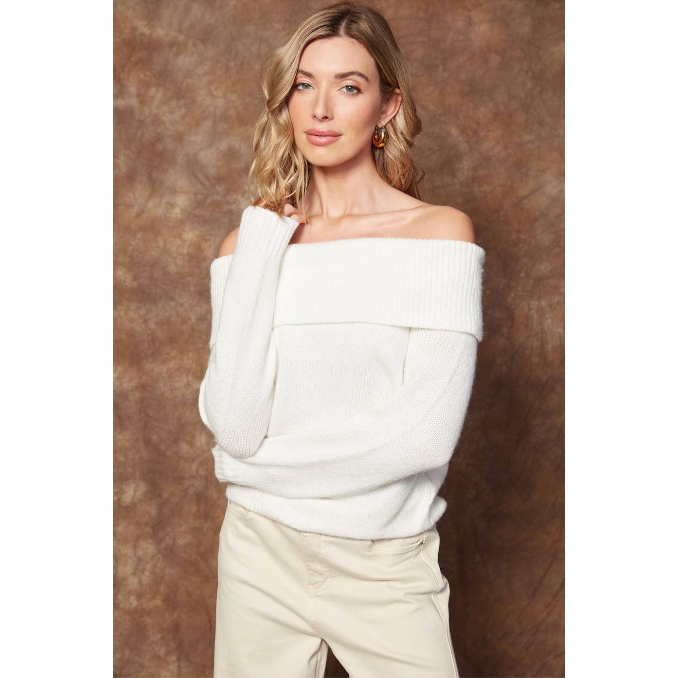 Model wearing Angelique Raglan Long Sleeve Sweater in white knit, off-shoulder neckline, relaxed fit.