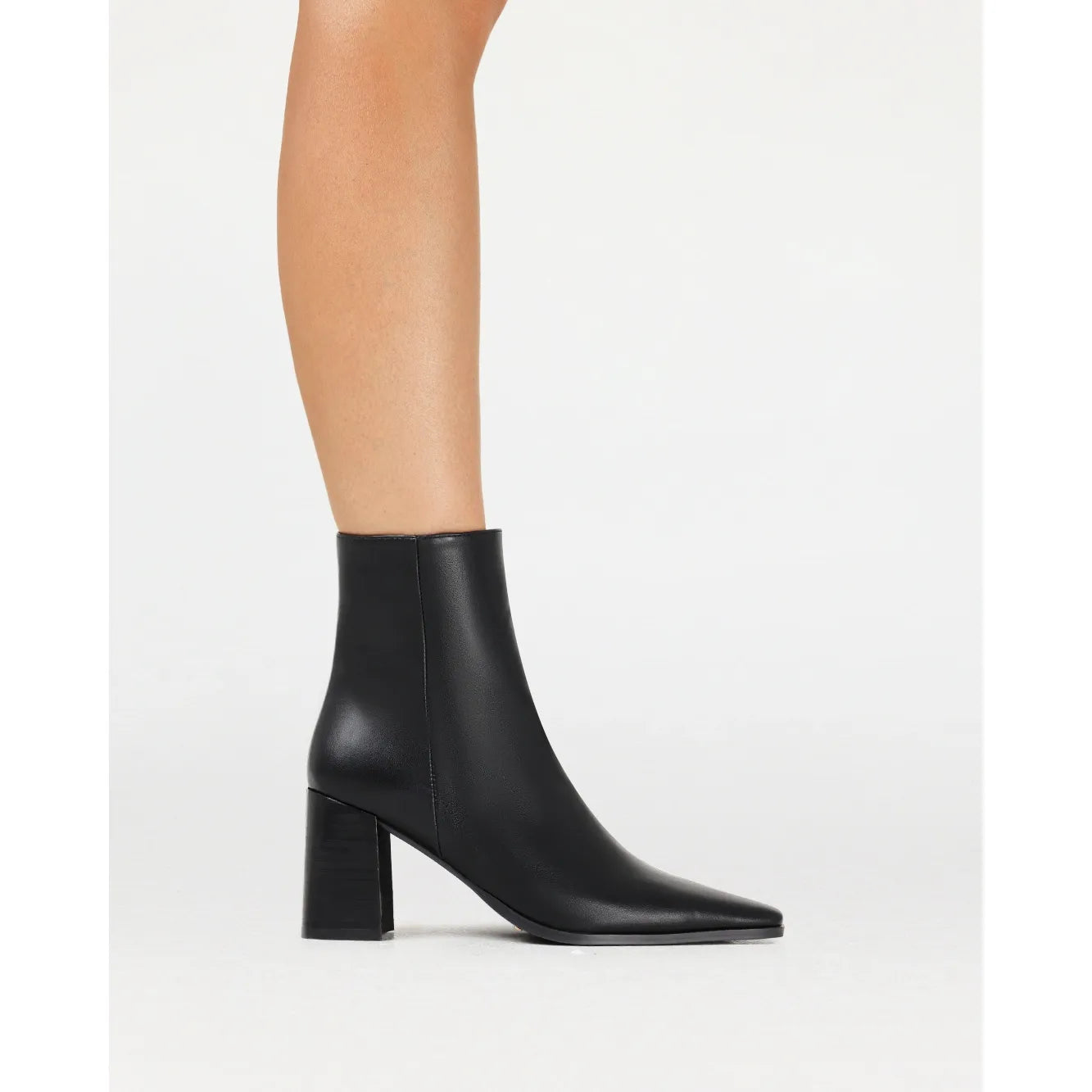 Black Billini Ozi boot featuring a sleek square toe and mid-flare block heel for effortless sophistication.