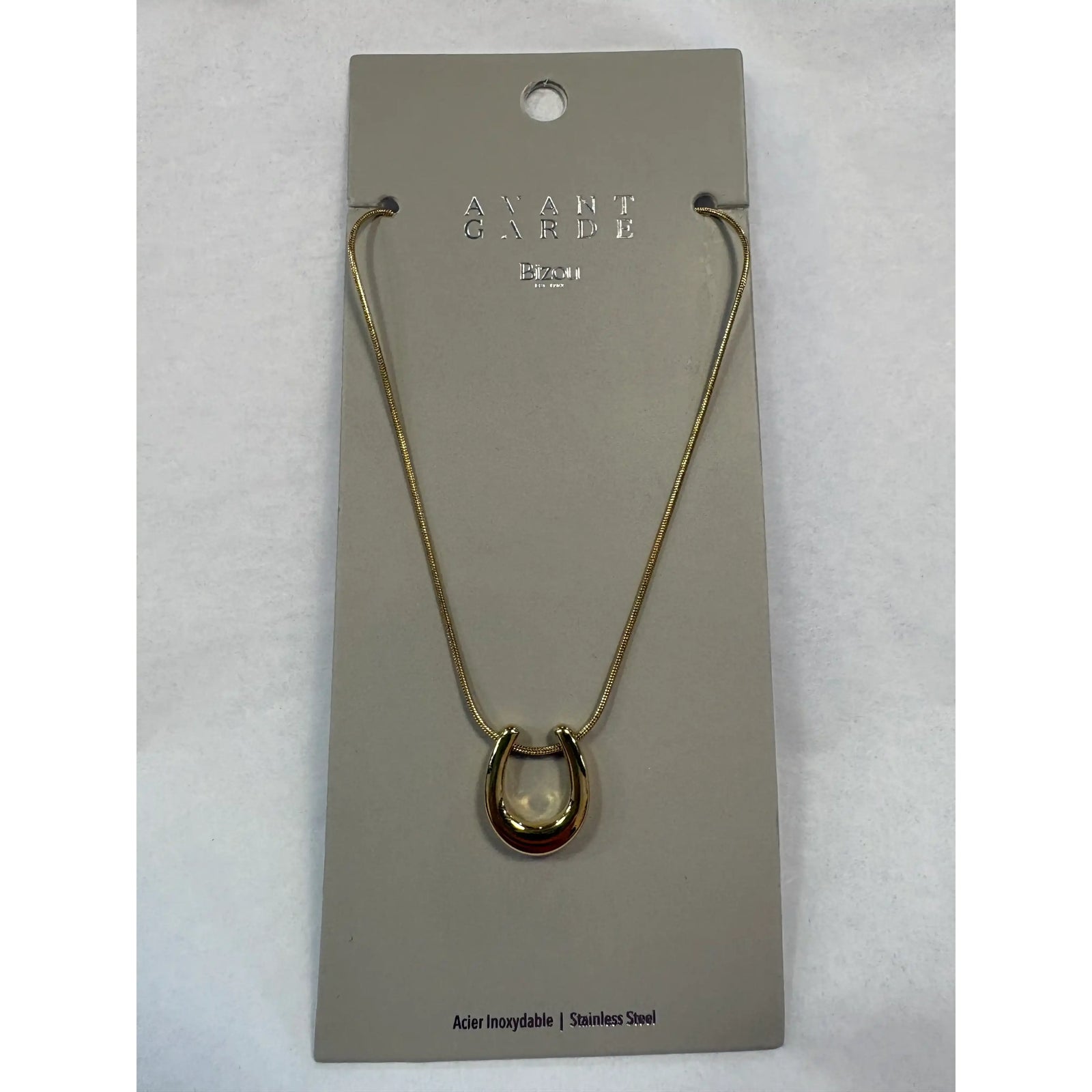 Gold-tone stainless steel Bizou horseshoe charm necklace on a fine chain. Dainty good luck pendant, hypoallergenic and water-resistant.