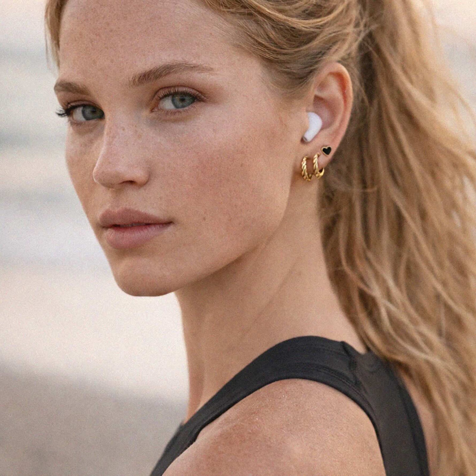 Wavy Gold-Tone Earrings: twisted textured stainless steel hoops catching light.