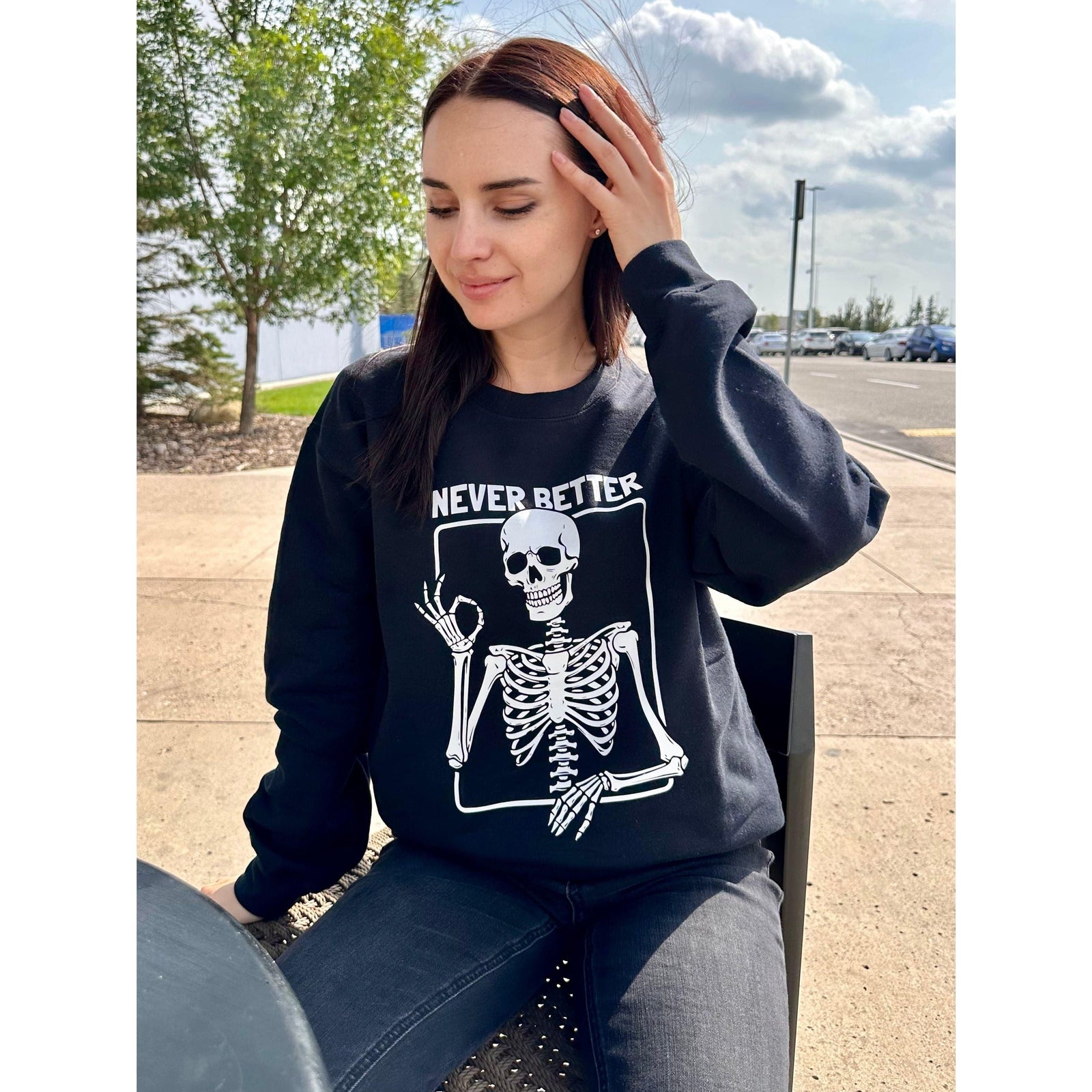 Never Better Crew Sweater by Blonde Ambition with a white skeleton graphic on black, worn by a model.