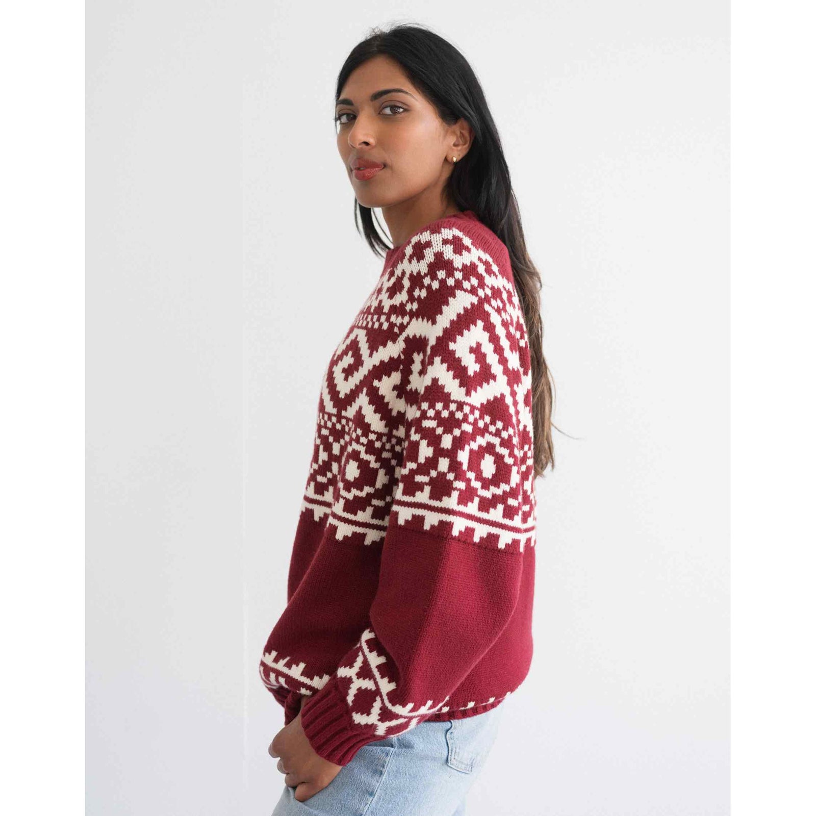 Brunette the Label Fair Isle Sweater worn by a model; oversized red knit with white geometric pattern.