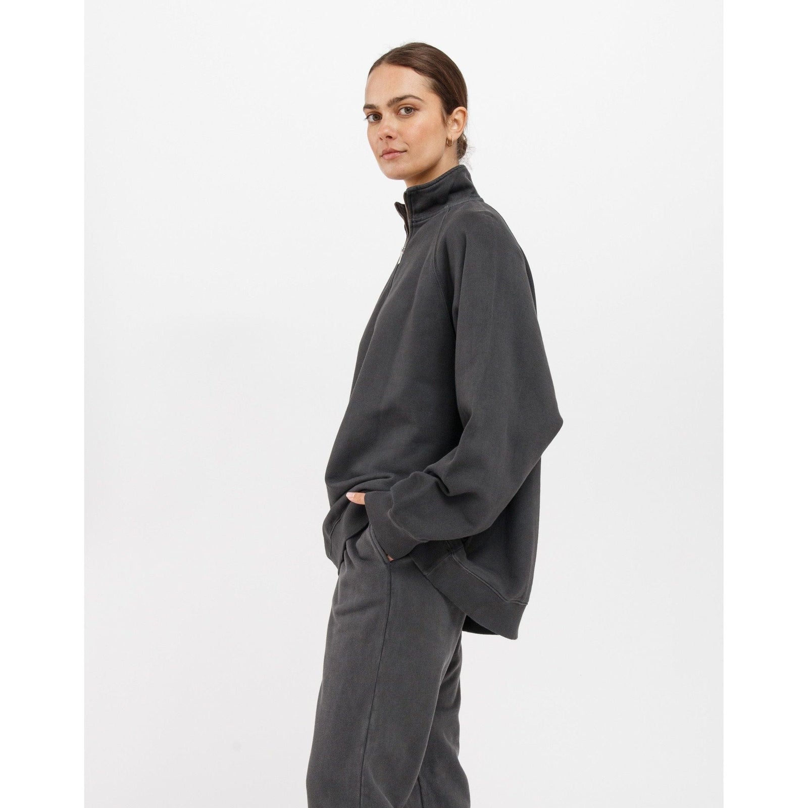 Brunette the Label Not Your Boyfriend's 1/2 Zip in charcoal, relaxed pullover with matching pants, model side profile.