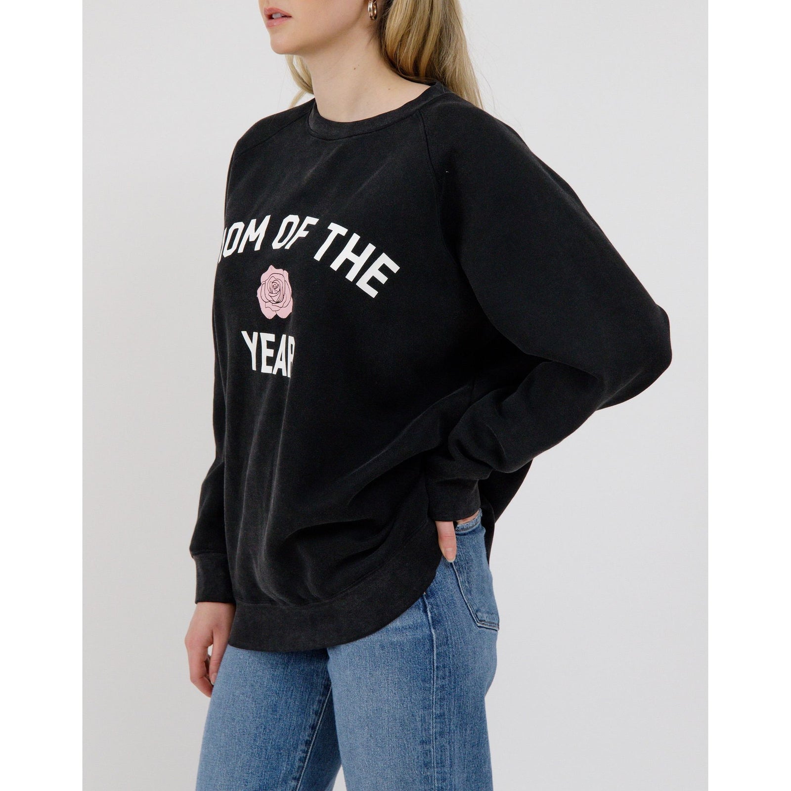 Stylish woman wearing the Brunette the Label Mom of the Year NYBF Crew, celebrating motherhood in comfort and luxury.