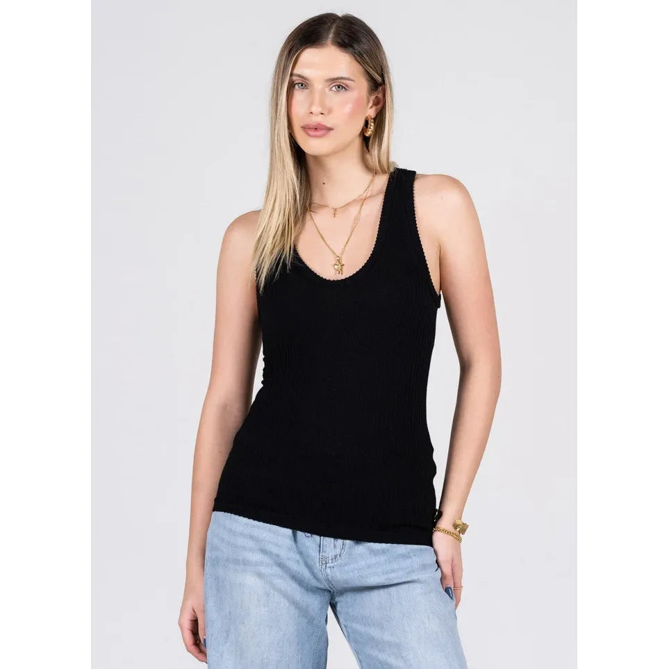 Black scoop-neck ribbed tank top with subtle texture, made from bamboo rayon blend, shown worn with light wash jeans.