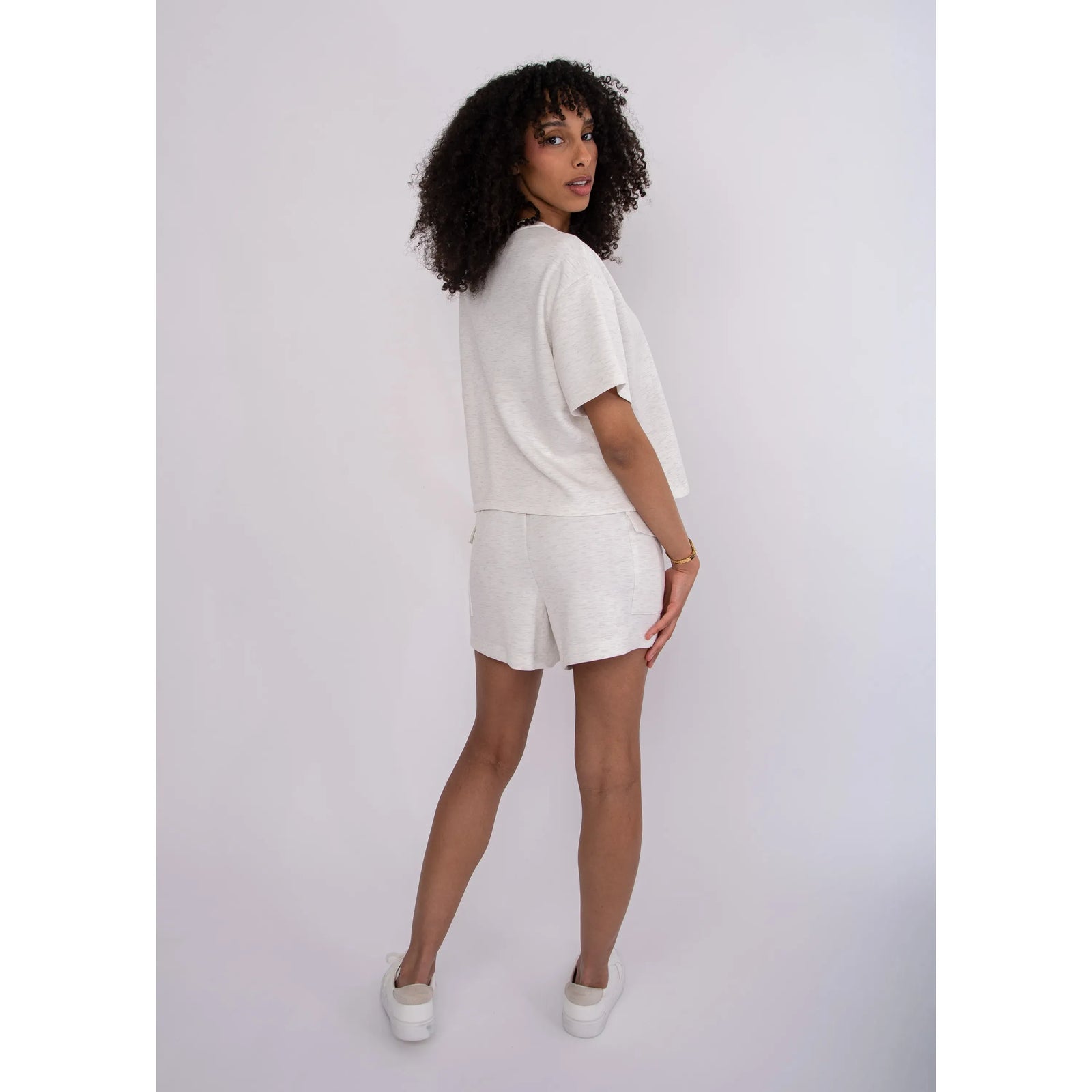 Darcia Soft Knit Drawstring Shorts in heathered ivory worn with a matching relaxed top.