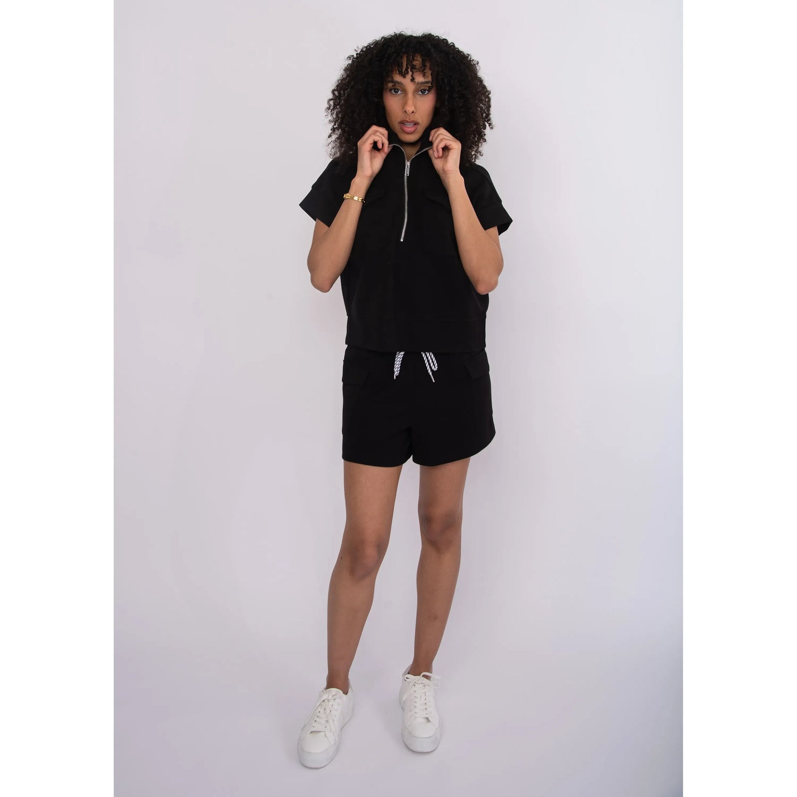 Darcia Soft Knit Drawstring Shorts in black on a model, with white sneakers.