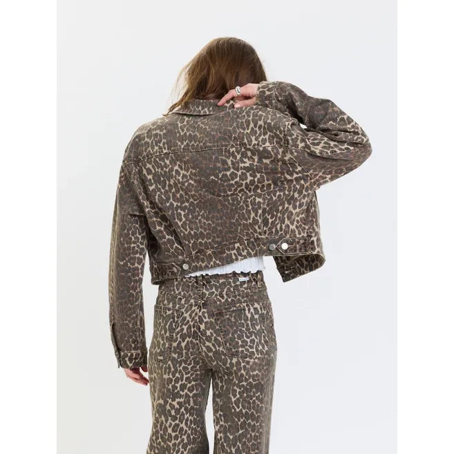 Back view of a cropped leopard print trucker jacket and matching wide-leg pants in a cool cat wash.