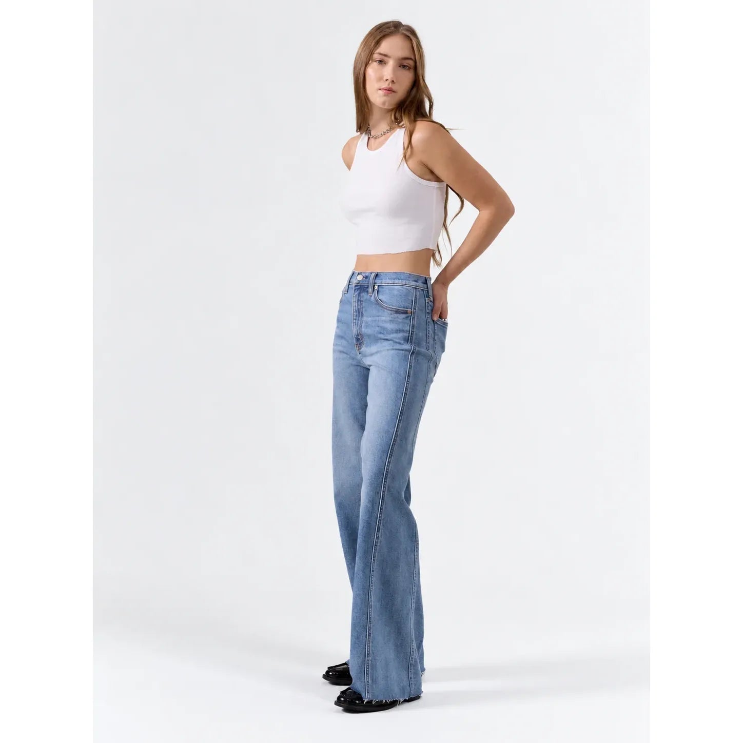 High rise wide leg jeans in vintage medium wash featuring paneled seams down the leg and a raw hem.