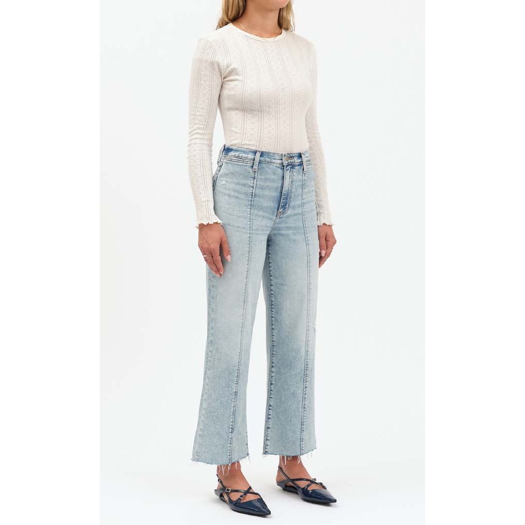 Woman wearing Daze Pleaser high-rise wide-leg ankle jeans in Cupid, light-wash with subtle fading and seaming.