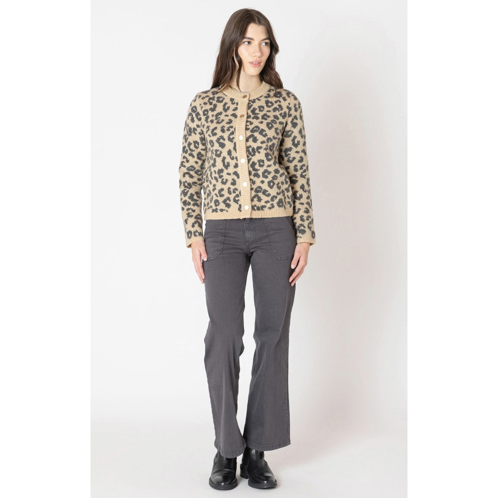 Woman wearing a beige leopard-print Dex Crewneck Print Cardigan, button-front knit, paired with gray pants.
