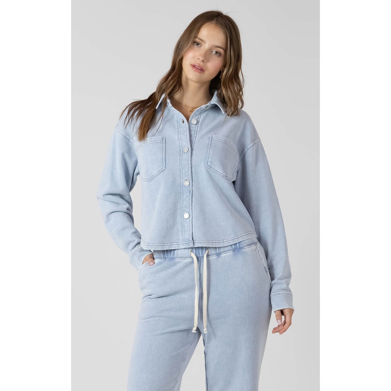 Dex Cropped Knit Overshirt in washed light denim with button front and chest pockets, paired with joggers.