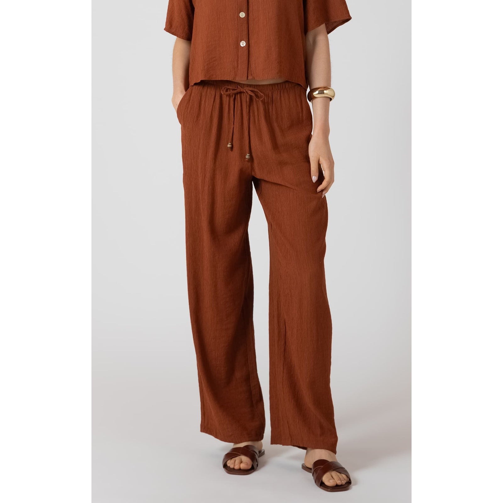 Dex Drawstring Wide Leg Pants in rust brown with breathable fabric, adjustable waist, and elastic back.