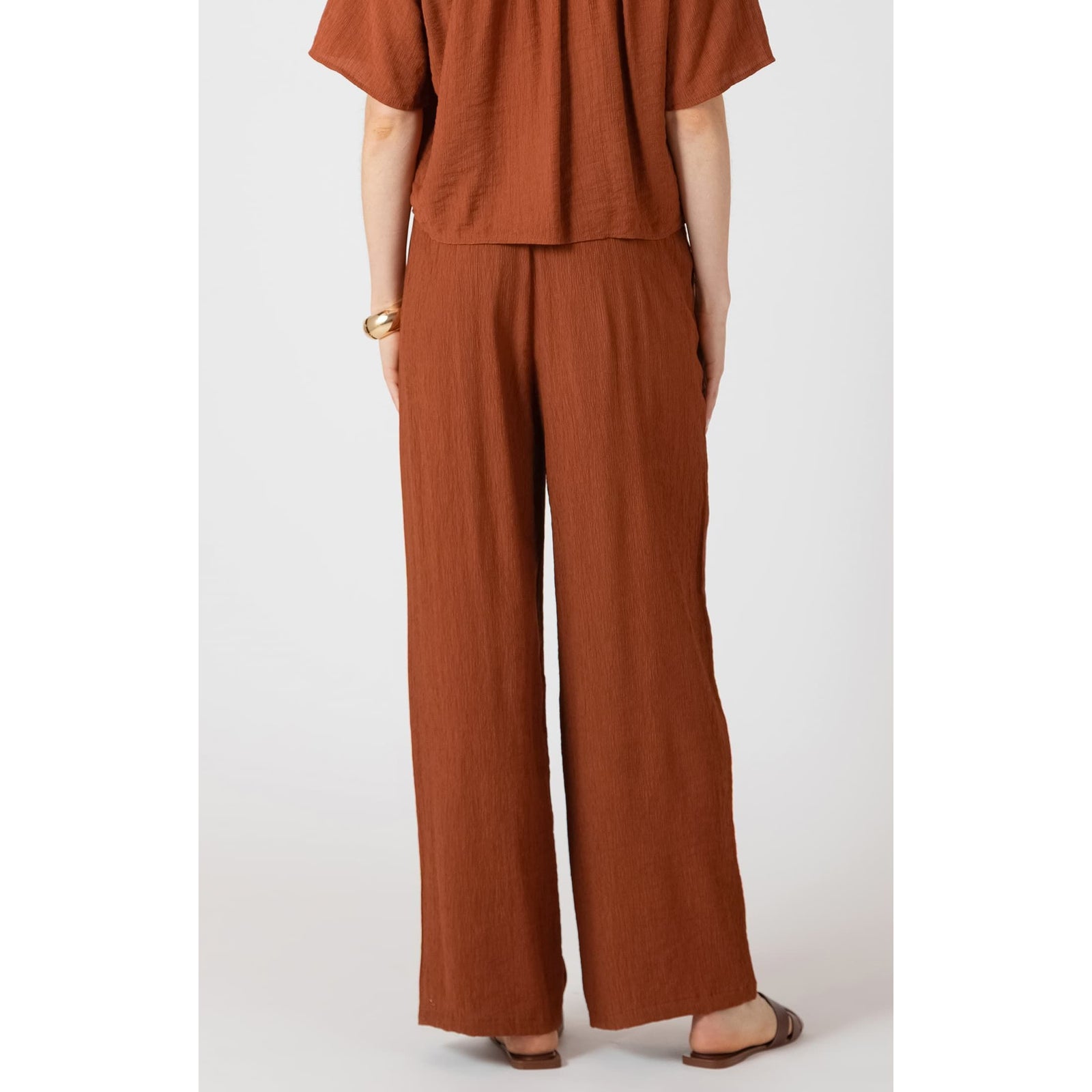 Dex Drawstring Wide Leg Pants in rust with breathable fabric, adjustable waist, back elastic for relaxed summer fit.