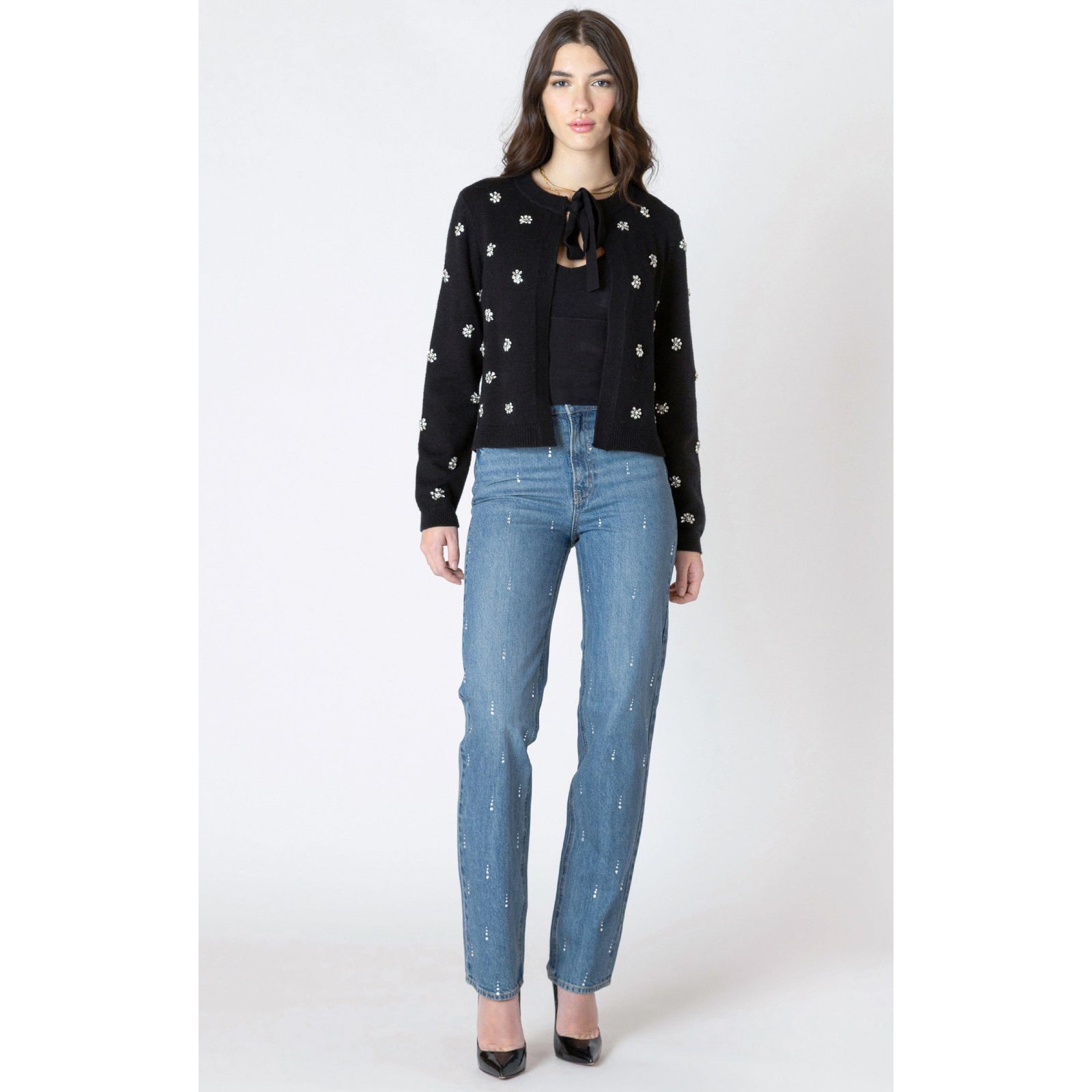 Dex Embellished Tie Front Cardigan with beaded embellishments and tie-front detail, worn over black top with jeans.