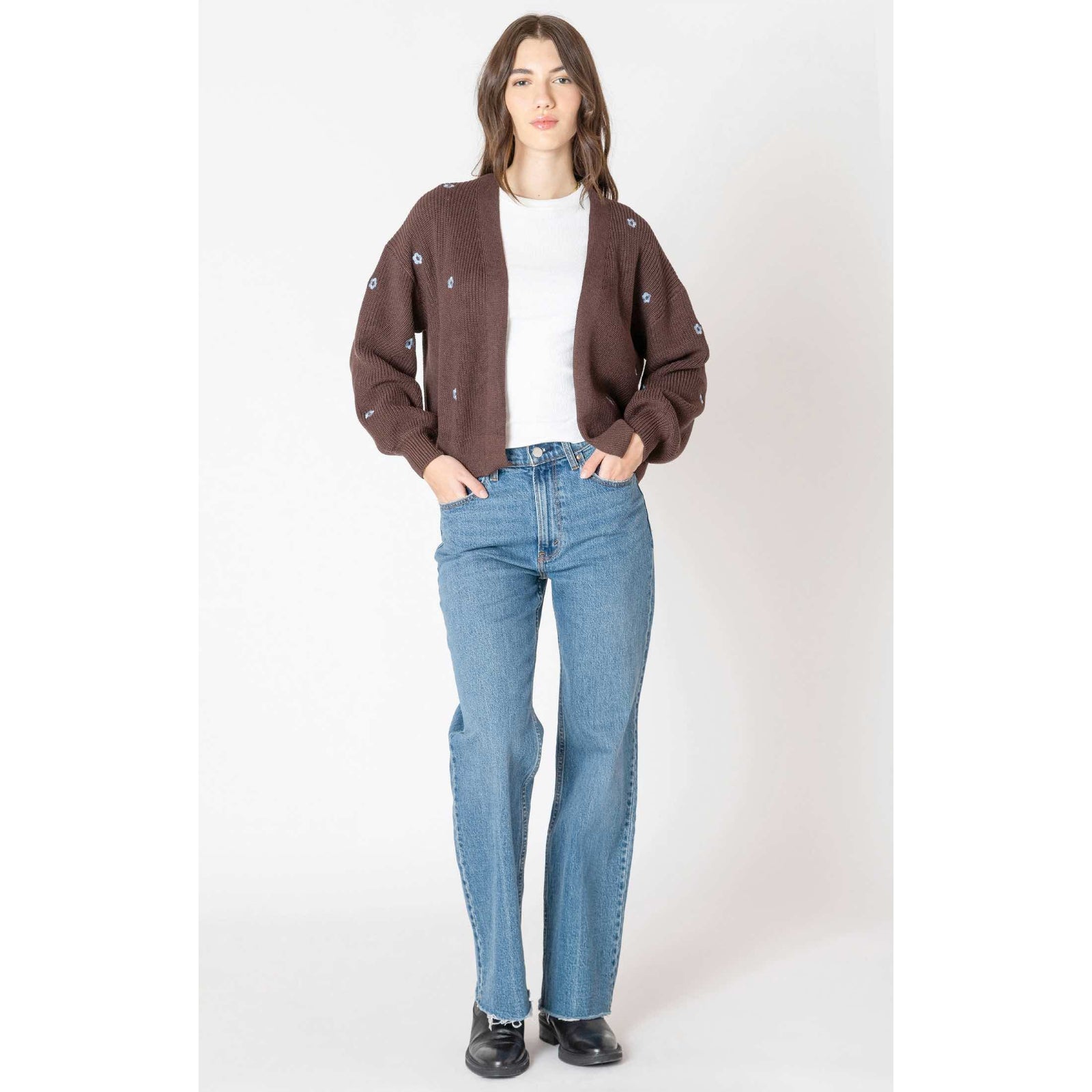 Dex Embroidered Open Cardigan in brown with blue floral embroidery, layered over a white tee and jeans.