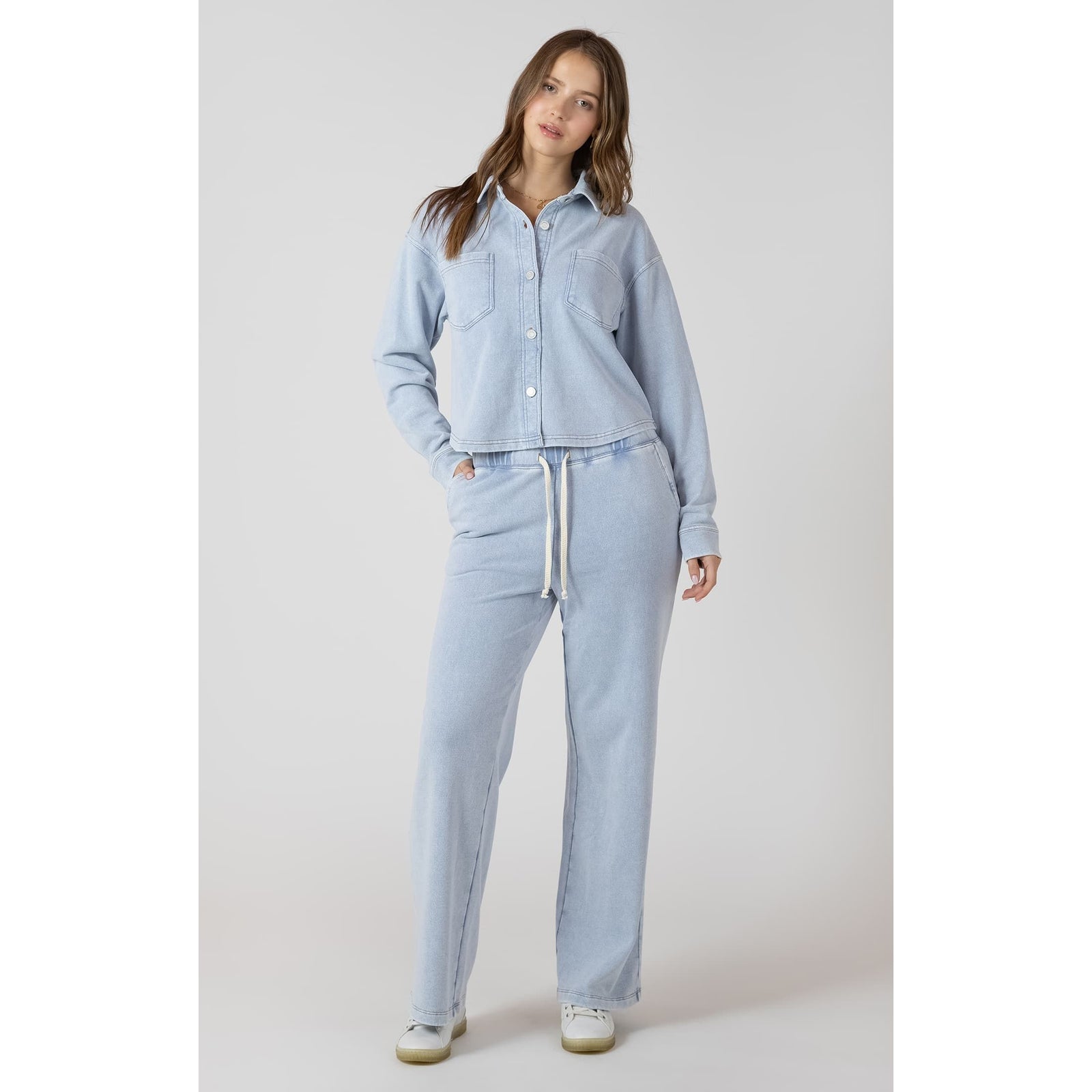 Model in Dex Knit Lounge Pant set: light blue knit with drawstring waist and matching button-down top.