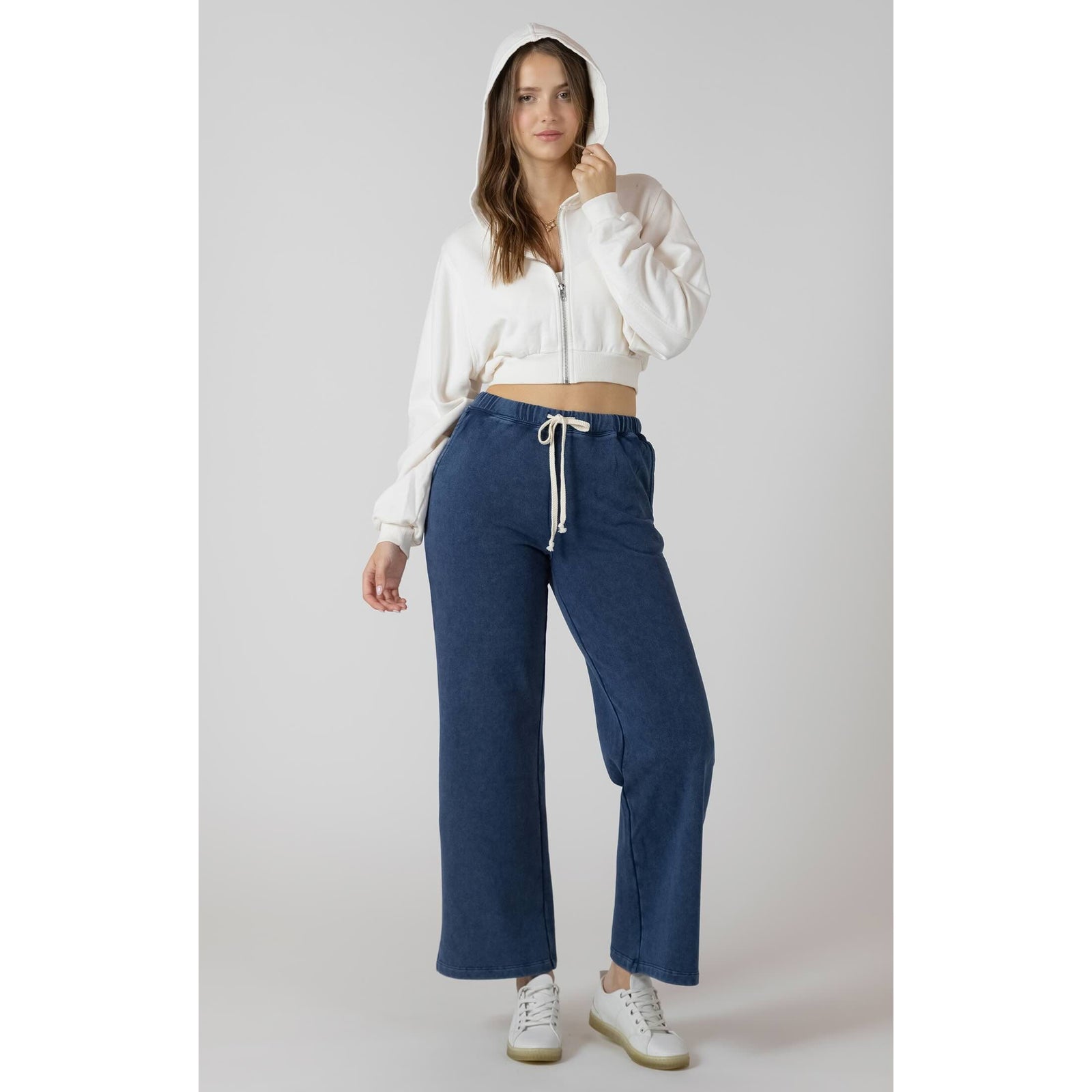 Dex Knit Lounge Pant in blue knit with drawstring waist, wide-leg, modeled with white cropped hoodie.