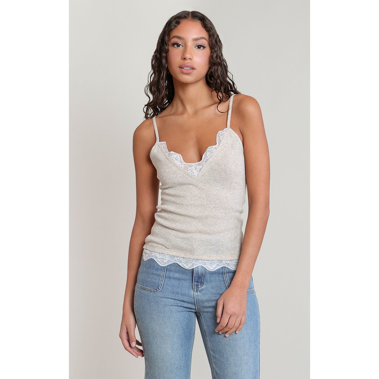 Dex Lace Cami: beige lace-trim V-neck camisole on a model, ideal for layering.