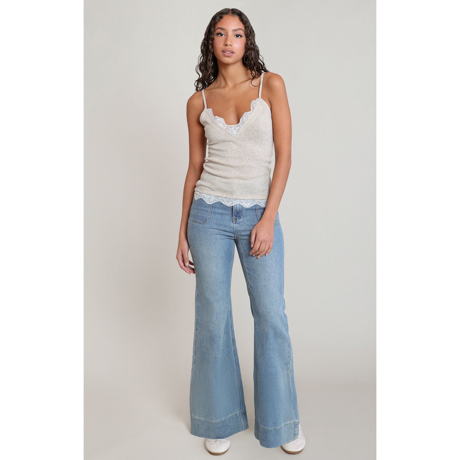 Dex Lace Cami in cream knit with lace-trim neckline and hem, modeled with denim flare jeans.