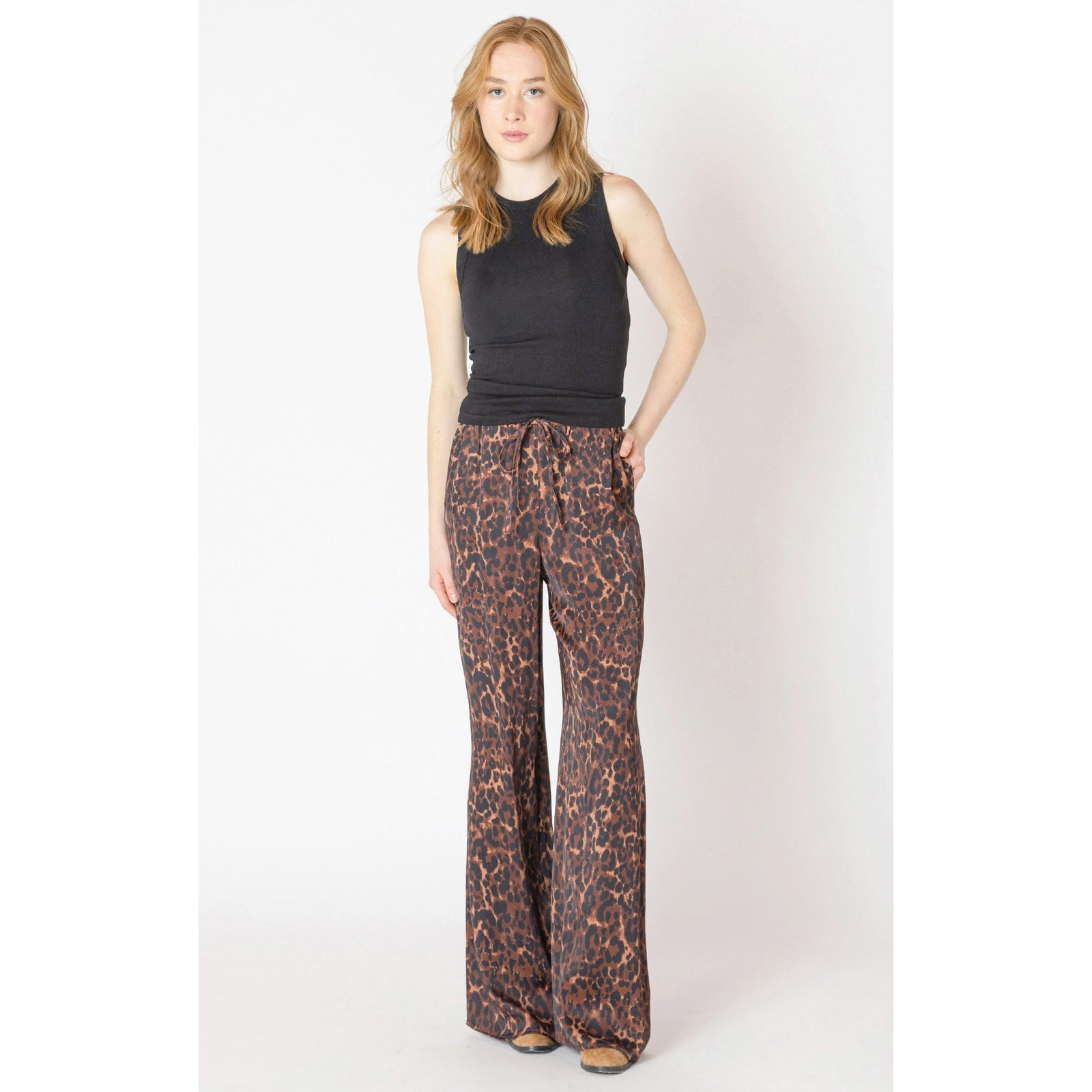 Dex Printed Flowy Pant in leopard print with drawstring waist, modeled with a black sleeveless top.