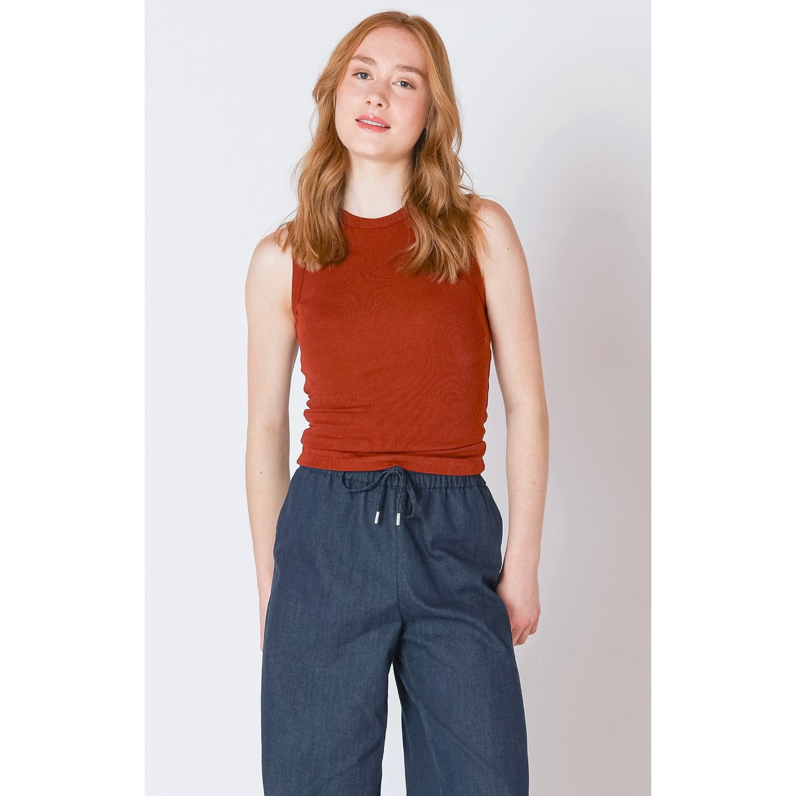 Burnt orange Dex Ribbed Tank Top offers a stylish, textured look perfect for layering or solo wear.