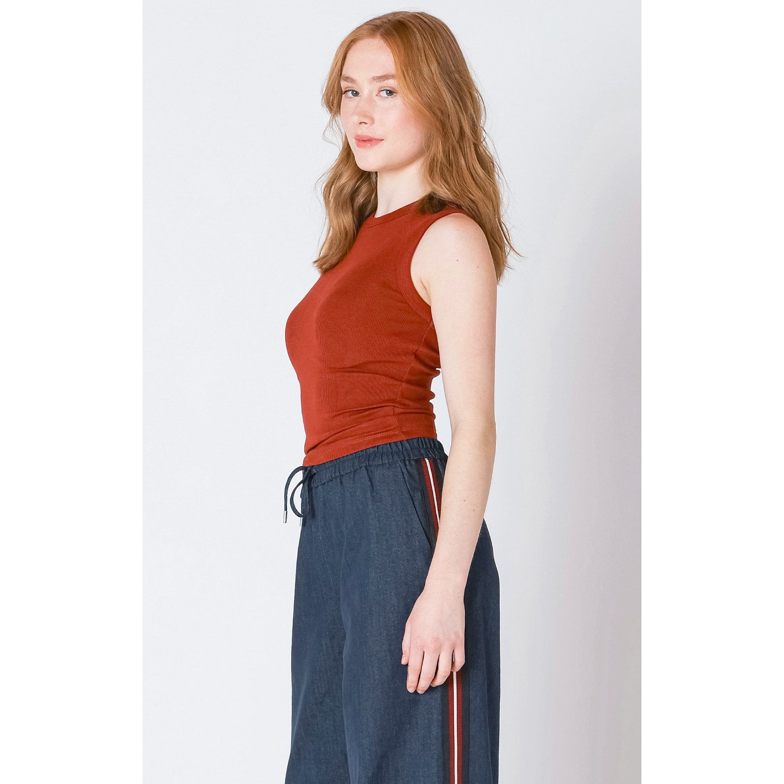 Stylish burnt orange Dex Ribbed Tank Top featuring soft ribbed fabric and classic crew neckline for versatile wear.