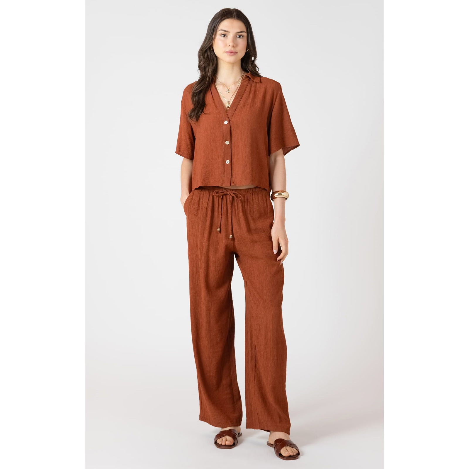 Dex Short Sleeve Blouse with V-neck in rust, relaxed fit, paired with drawstring pants for effortless summer style.