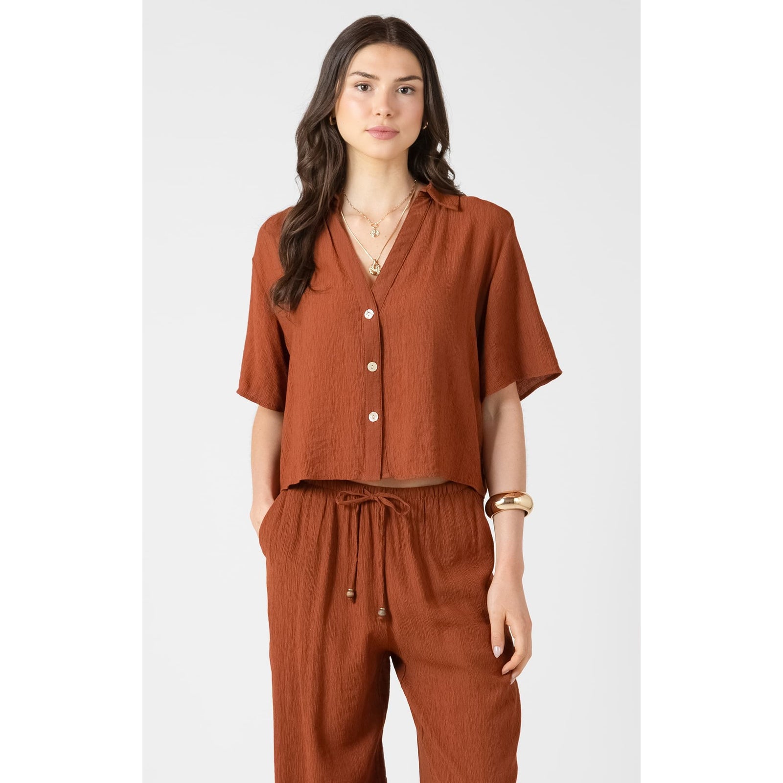 Dex Short Sleeve Blouse in rust with V-neck, button-front, relaxed fit; shown with matching drawstring pants.