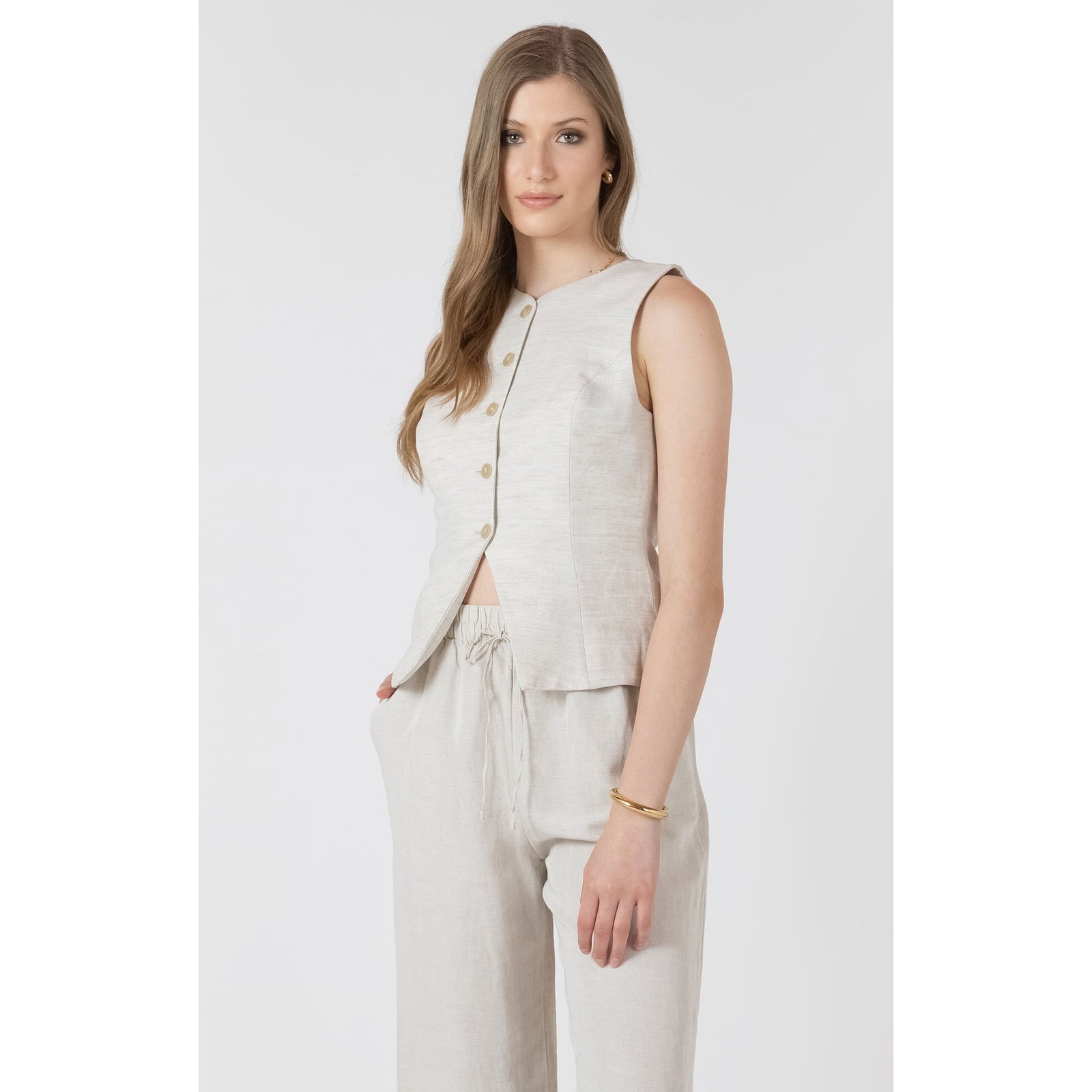 Beige Dex Summer Vest on a model, sleeveless button-front linen top with matching drawstring pants.