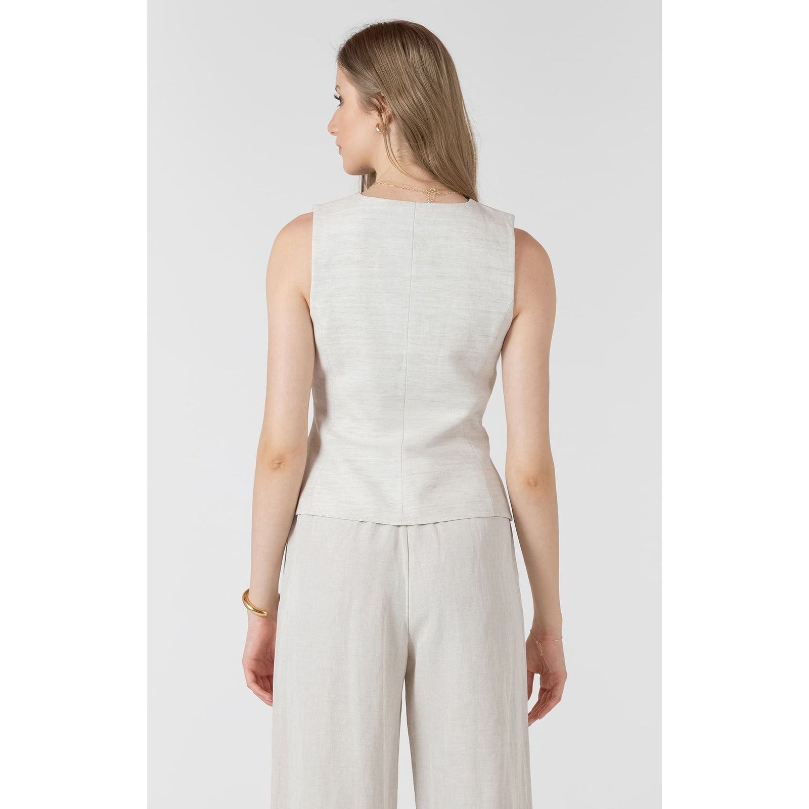 Back view of a sleeveless light beige Dex Summer Vest worn by a model.