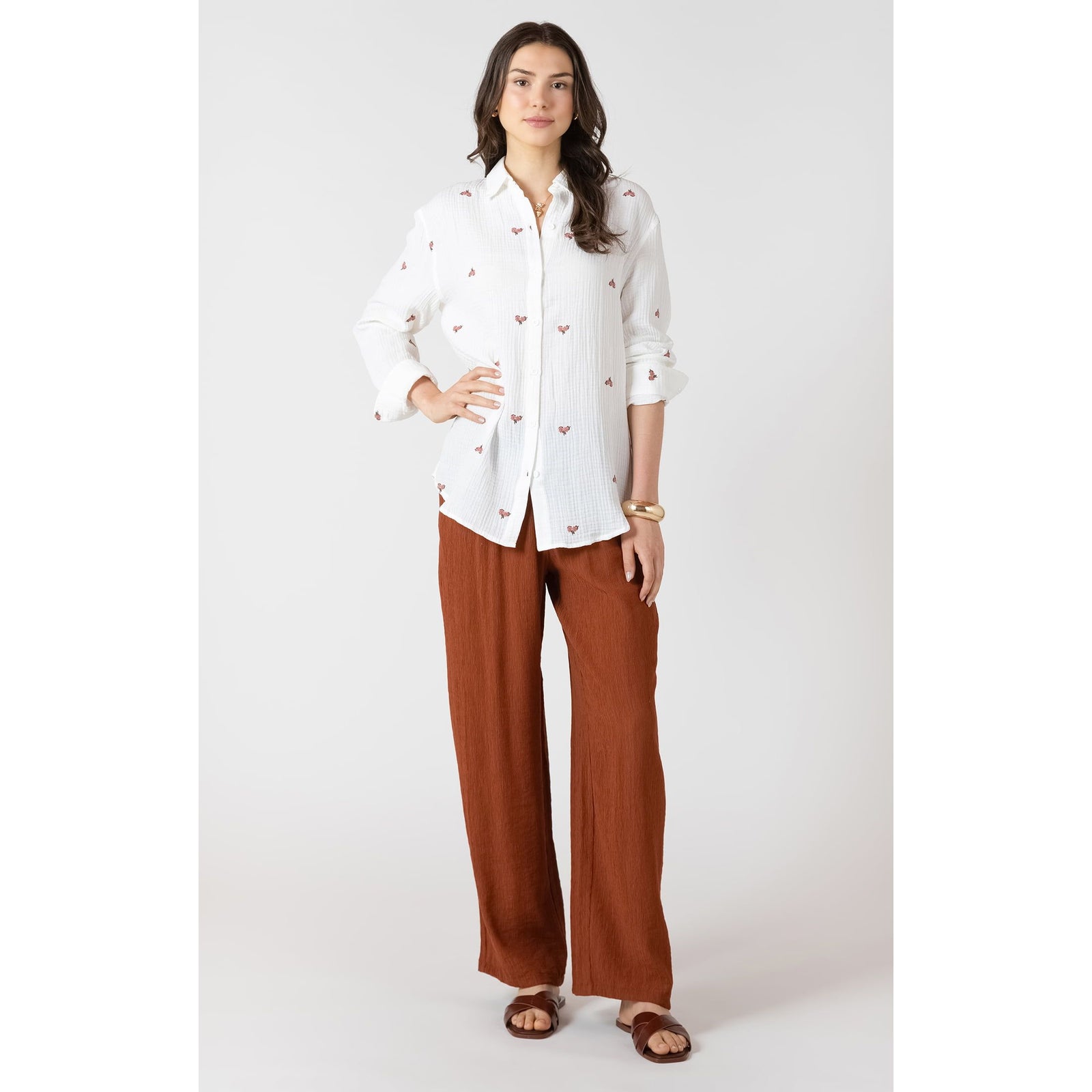 Dex Textured Floral Blouse: white textured long-sleeve blouse with small floral accents, relaxed fit, rust pants.