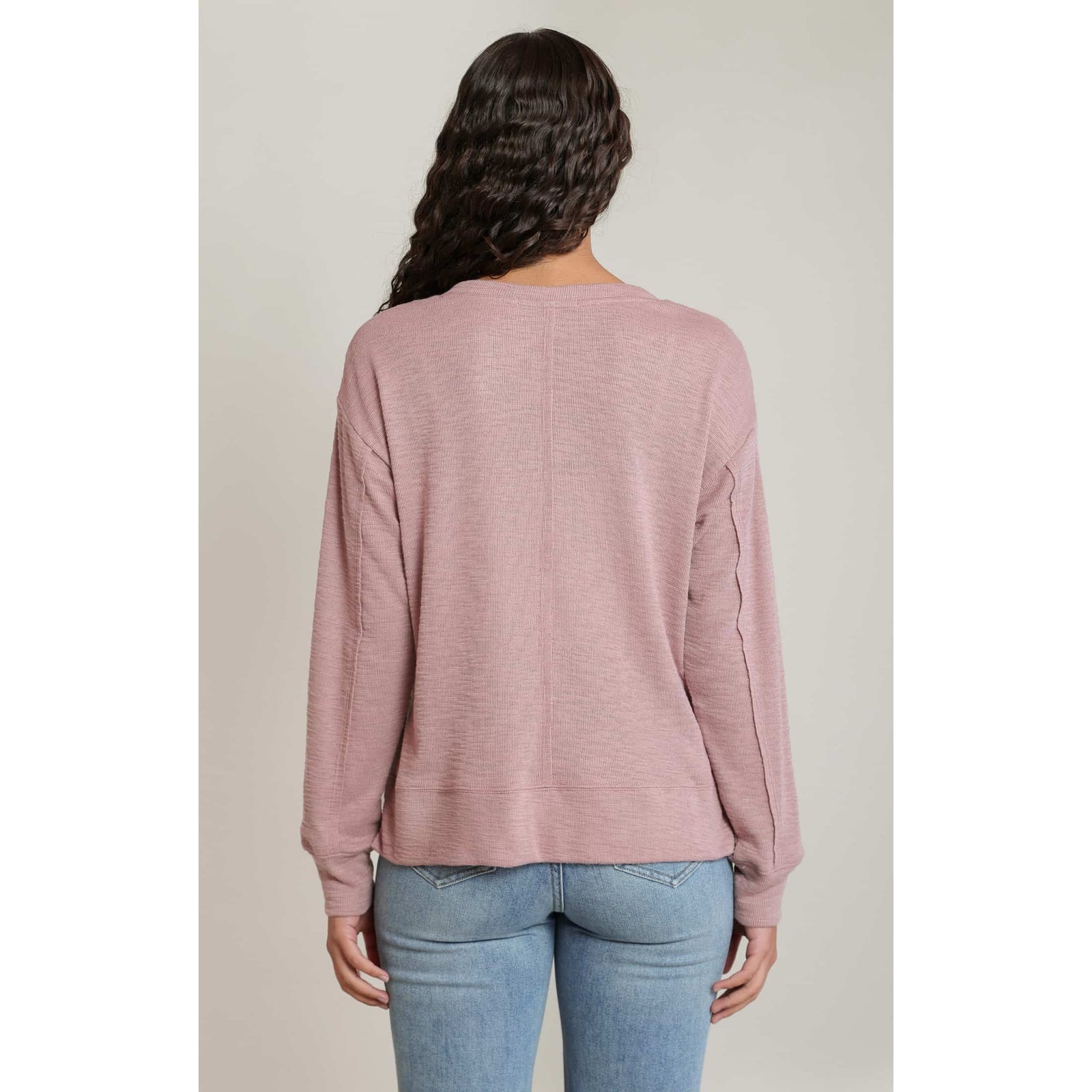 Dex V-Neck Long Sleeve Knit Top in dusty pink, back view showcasing relaxed knit fabric and raw seams.