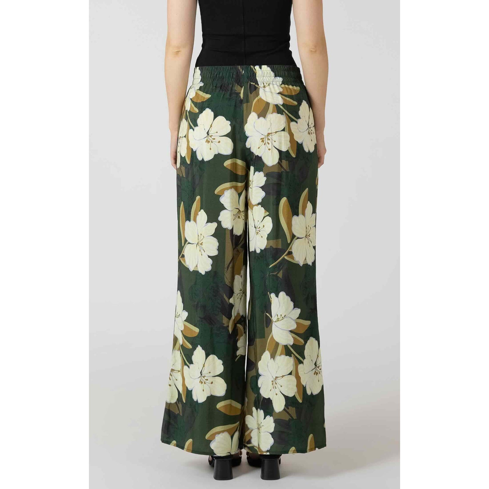 Back view of Dex Wide Leg Flowy Pants in green with white floral print and elastic waistband, wide-leg silhouette.