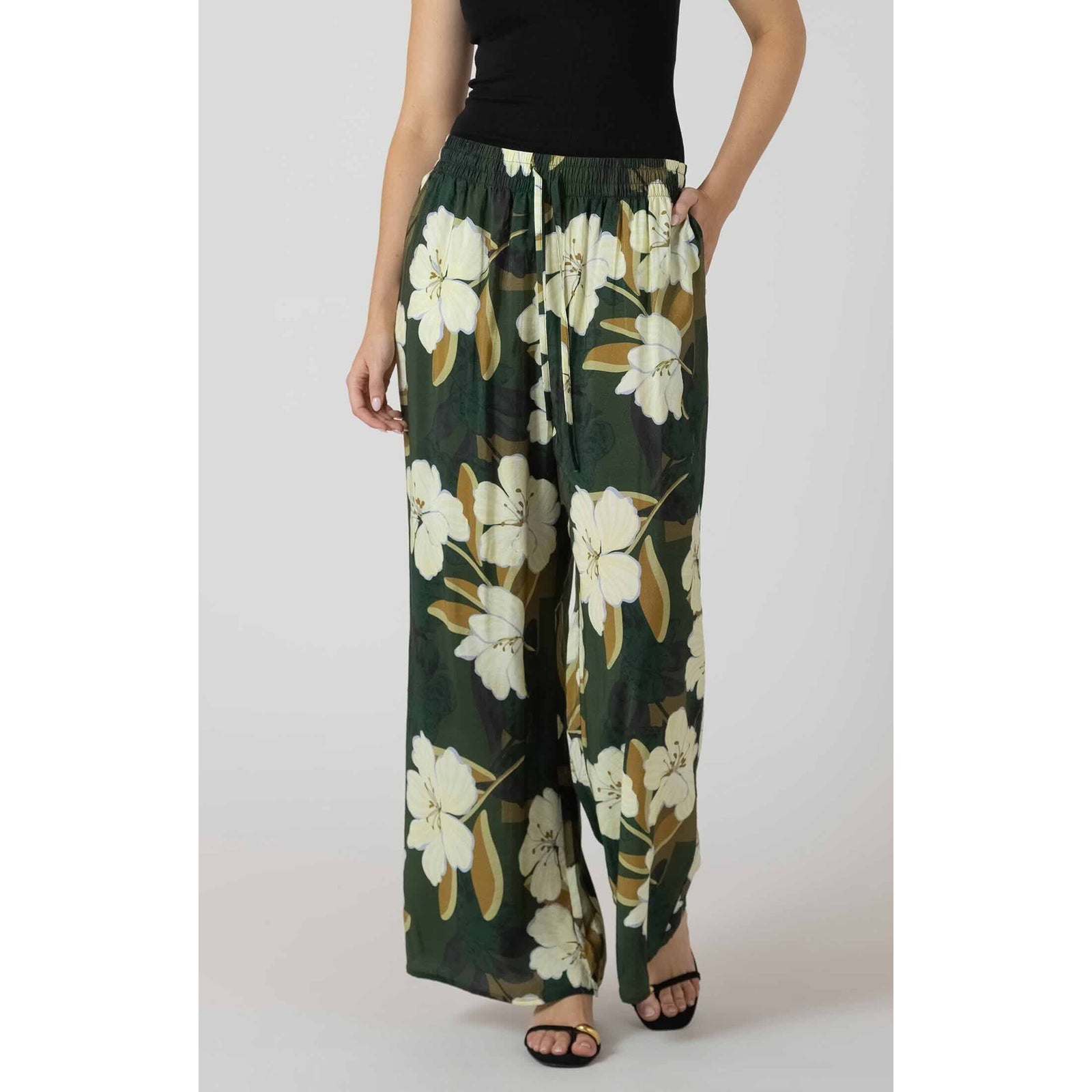 Dex Wide Leg Flowy Pants in dark green floral print with a drawstring elastic waist and relaxed wide legs
