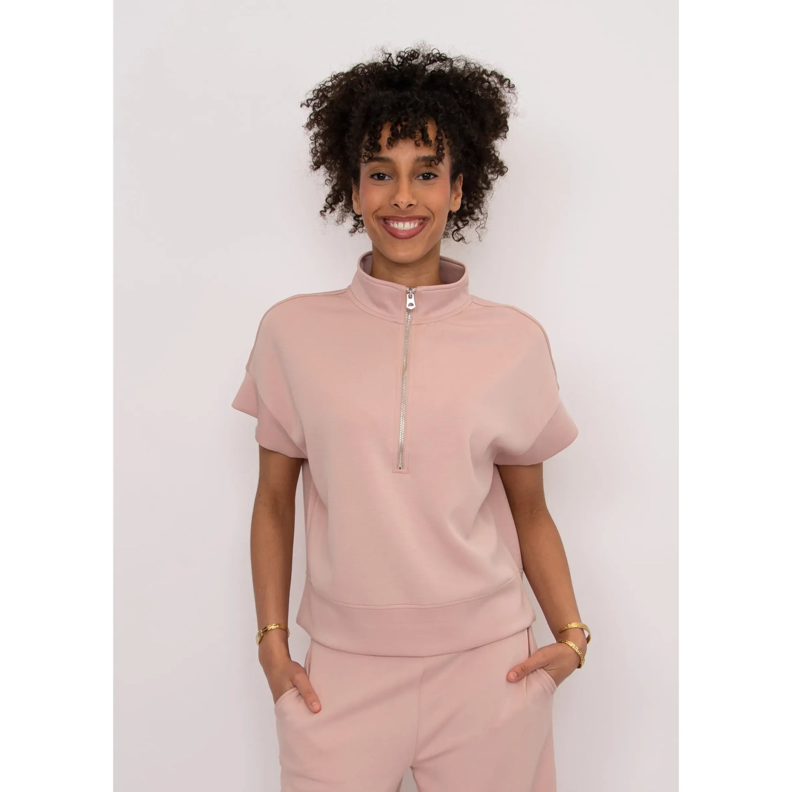 Dua Soft Knit 1/2 Zip Top in blush pink with front zip, short cuffed sleeves, and relaxed fit.
