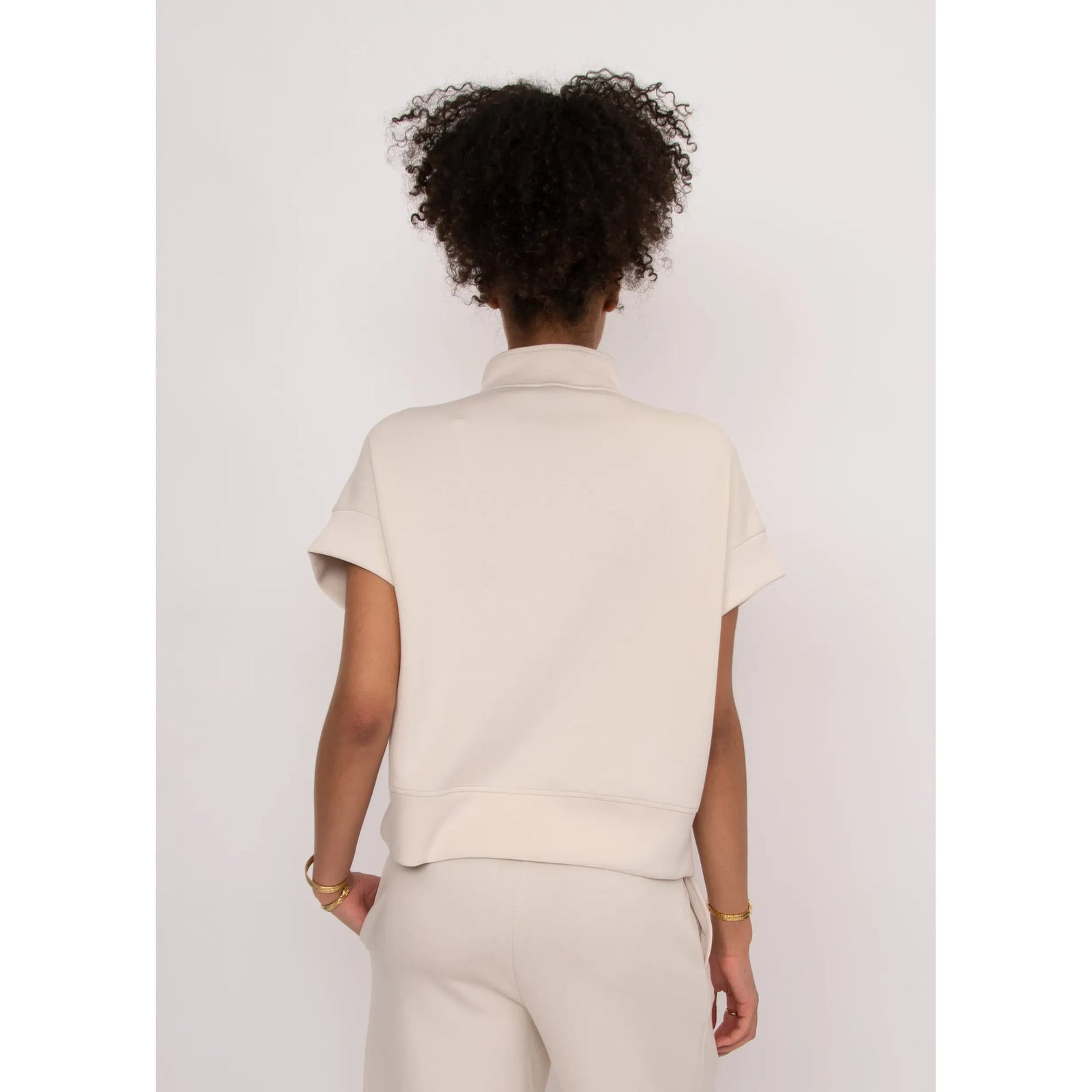 Dua Soft Knit 1/2 Zip Top in cream, back view with rolled short sleeves.