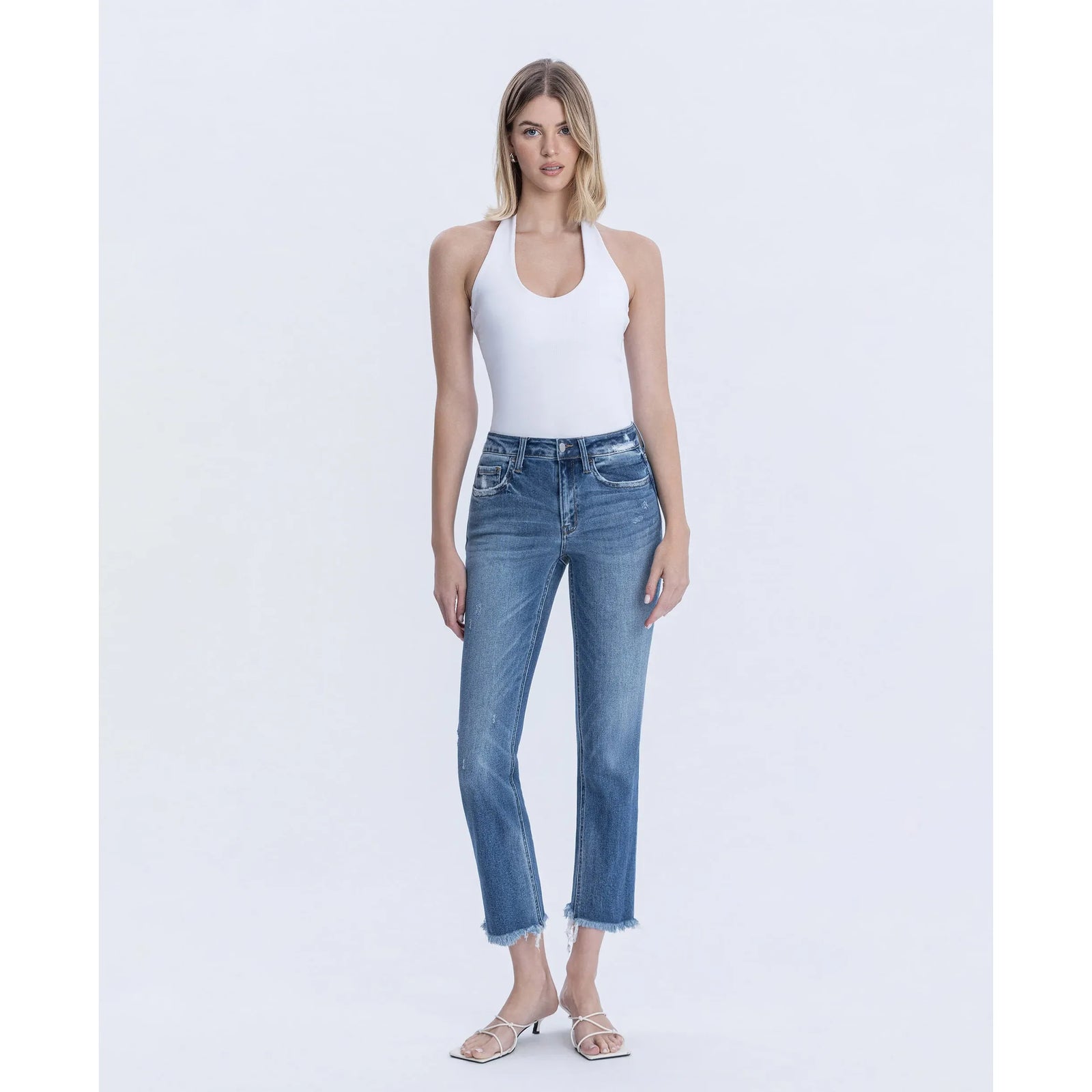 Model wearing Flying Monkey Congenial mid-rise slim-straight crop jeans with stretch denim and frayed hem.