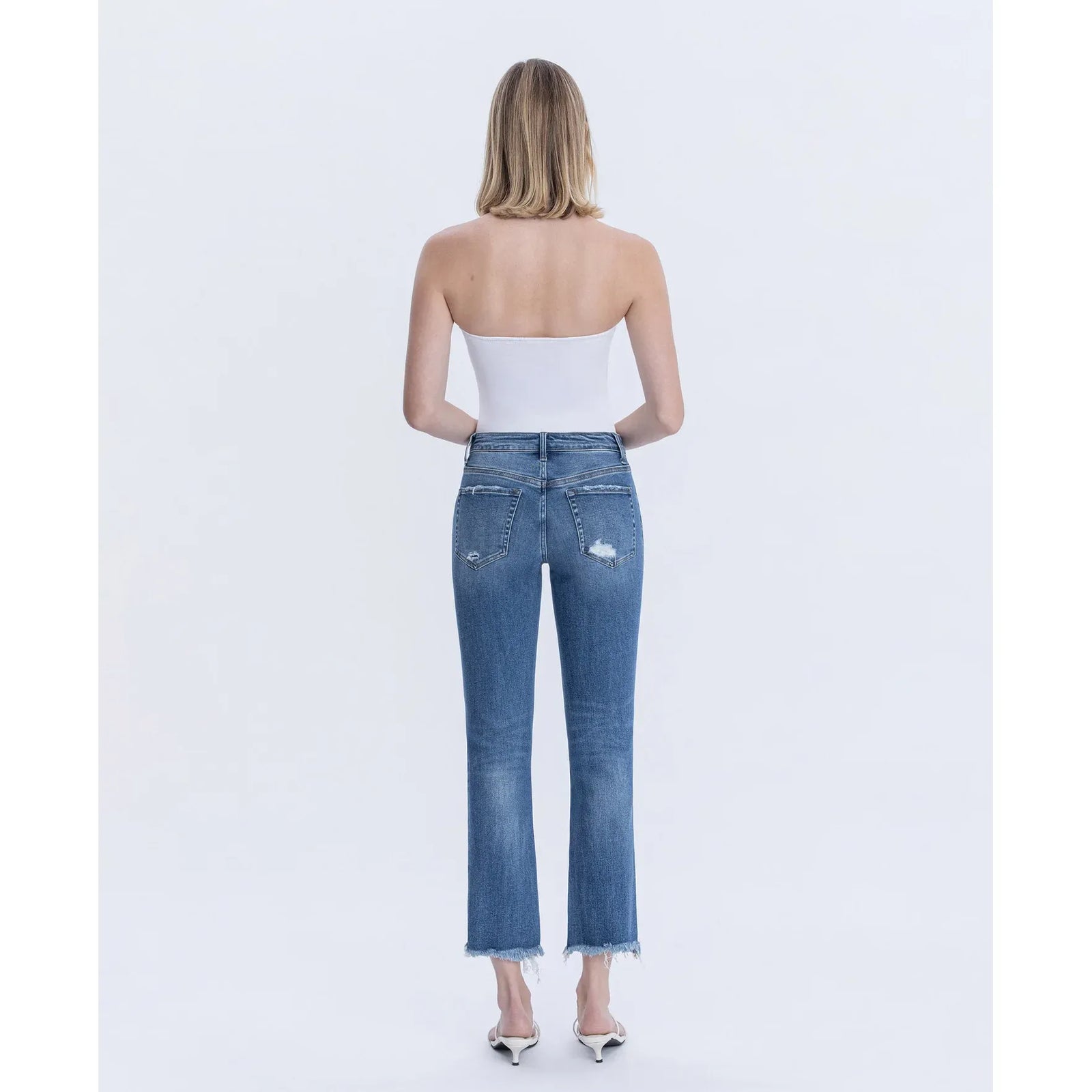 Back view of Flying Monkey Congenial mid-rise slim-straight crop jeans in blue with distressed pockets and frayed hem.