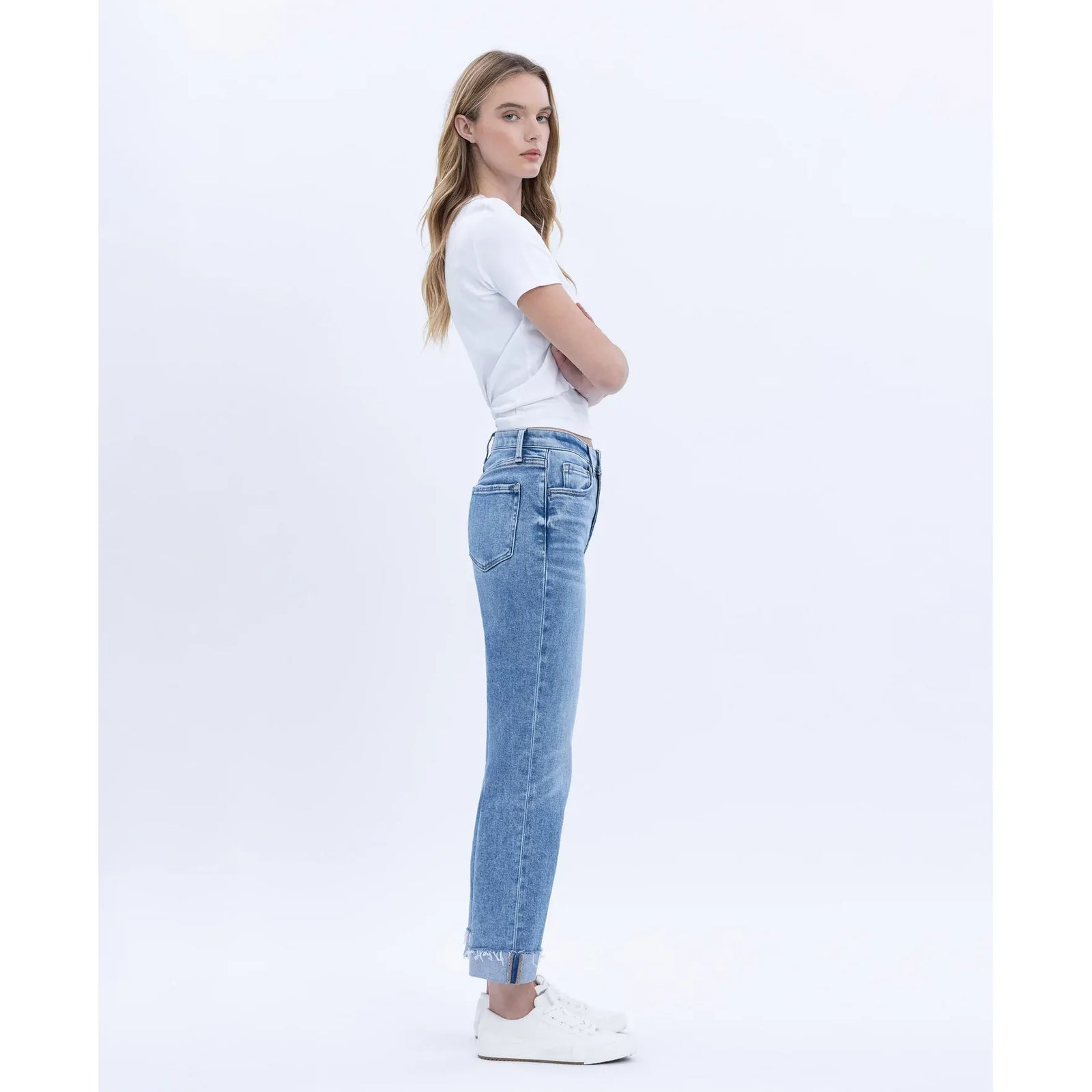 Model wearing Flying Monkey Delectable High Rise Straight Cuffed Crop jeans in light wash with white tee and sneakers.
