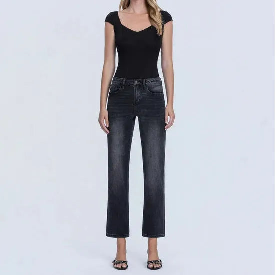 Dark wash high rise ankle straight jeans with a sleek fit, modeled with a black top against a white background.