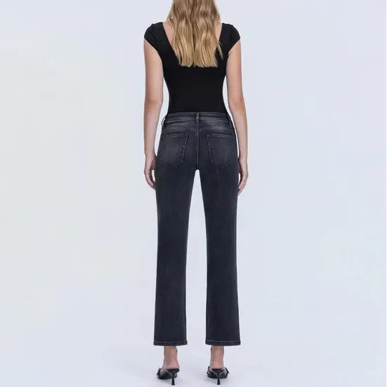 Back view of dark grey high rise ankle straight jeans with a sleek fit, worn with a black top and heels.
