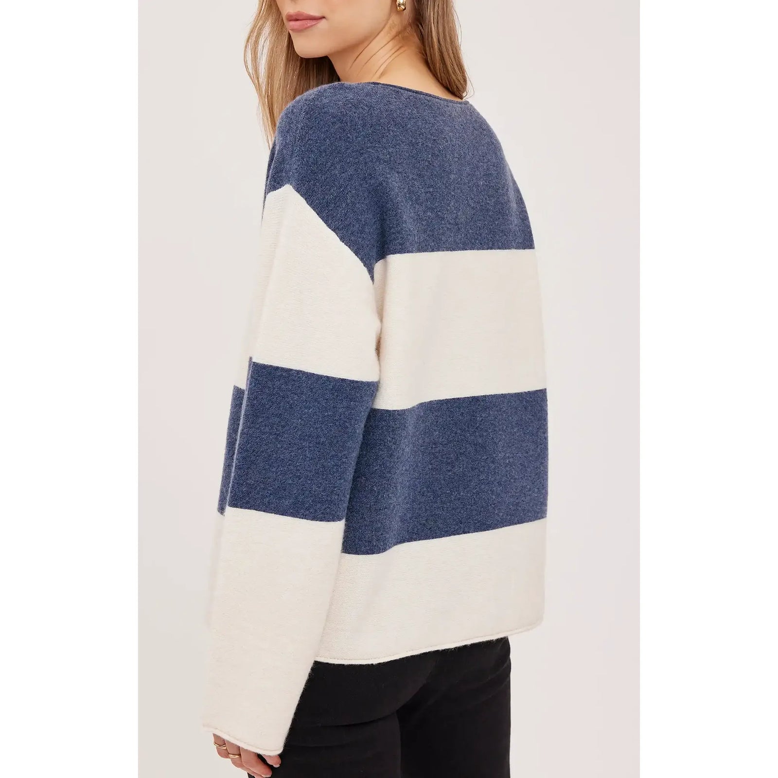 Navy and cream oversized V-neck sweater featuring soft textured knit stripes and relaxed fit details.