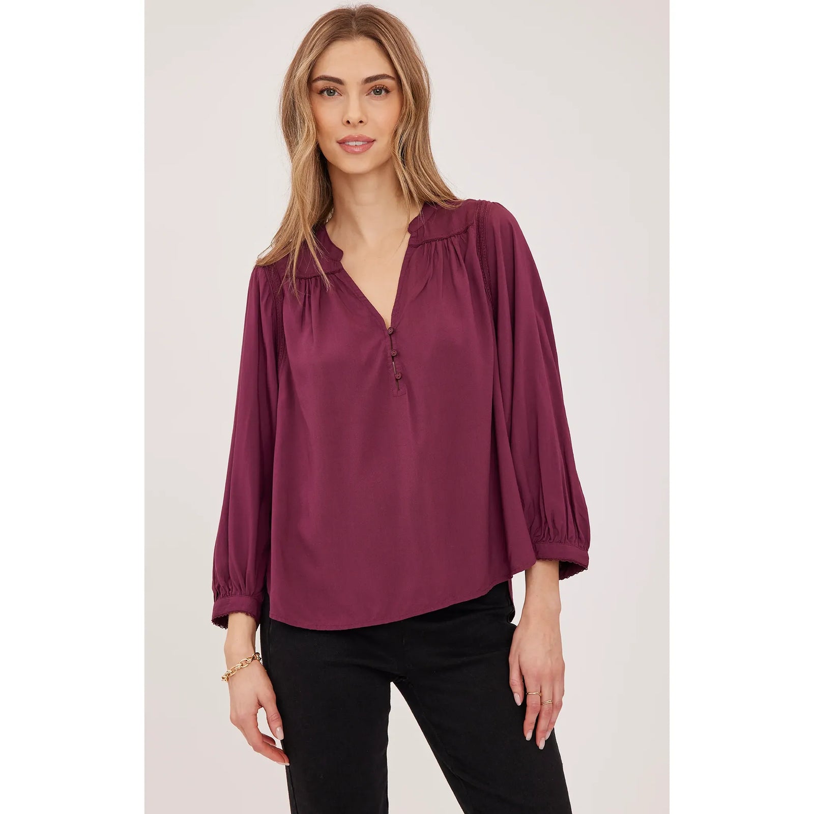 Burgundy viscose blouse with button-front closure, gathered sleeves, and delicate lace trim details for elegant everyday wear.