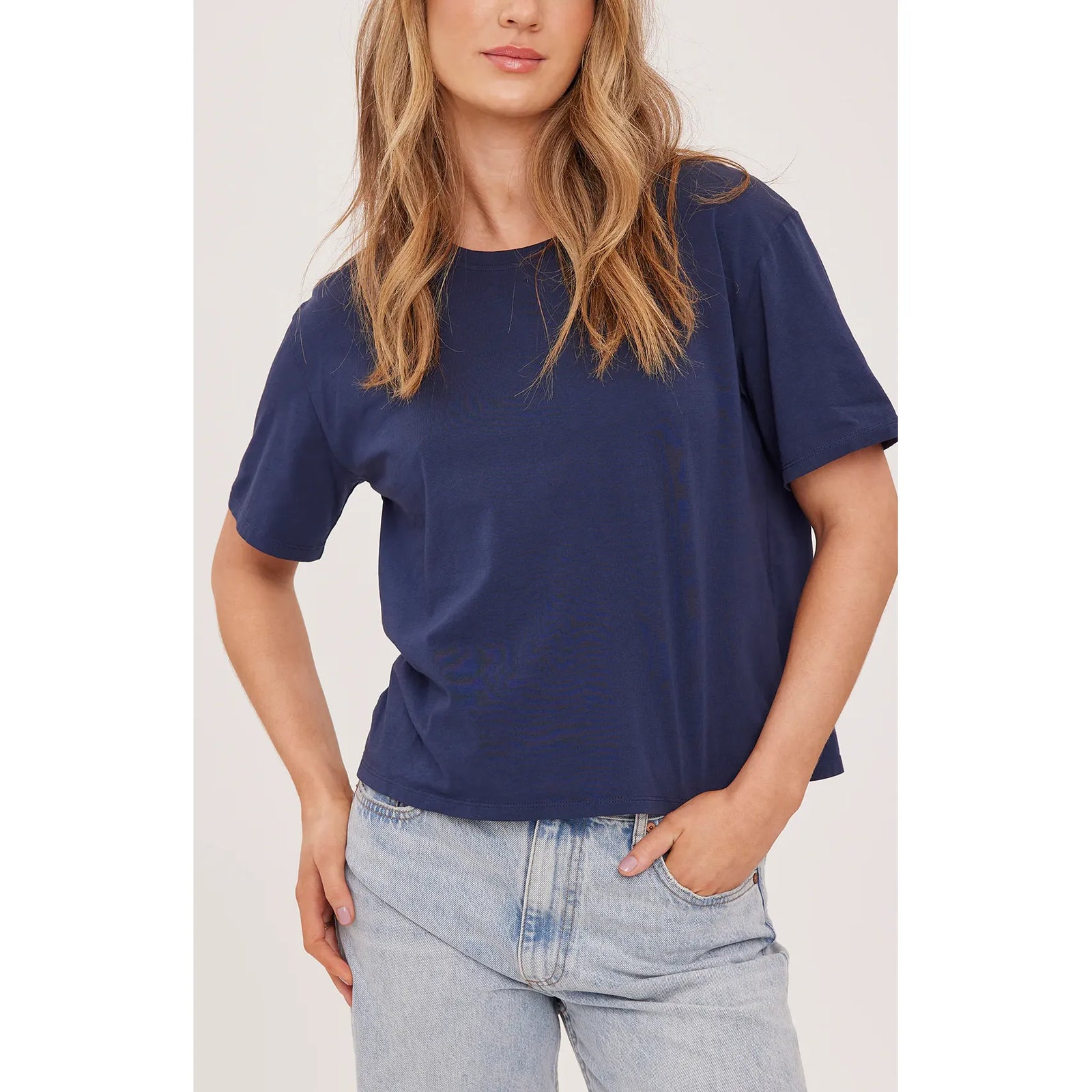 Navy Gentle Fawn Brigitte Tshirt with a relaxed crew neck on a model, paired with light denim.